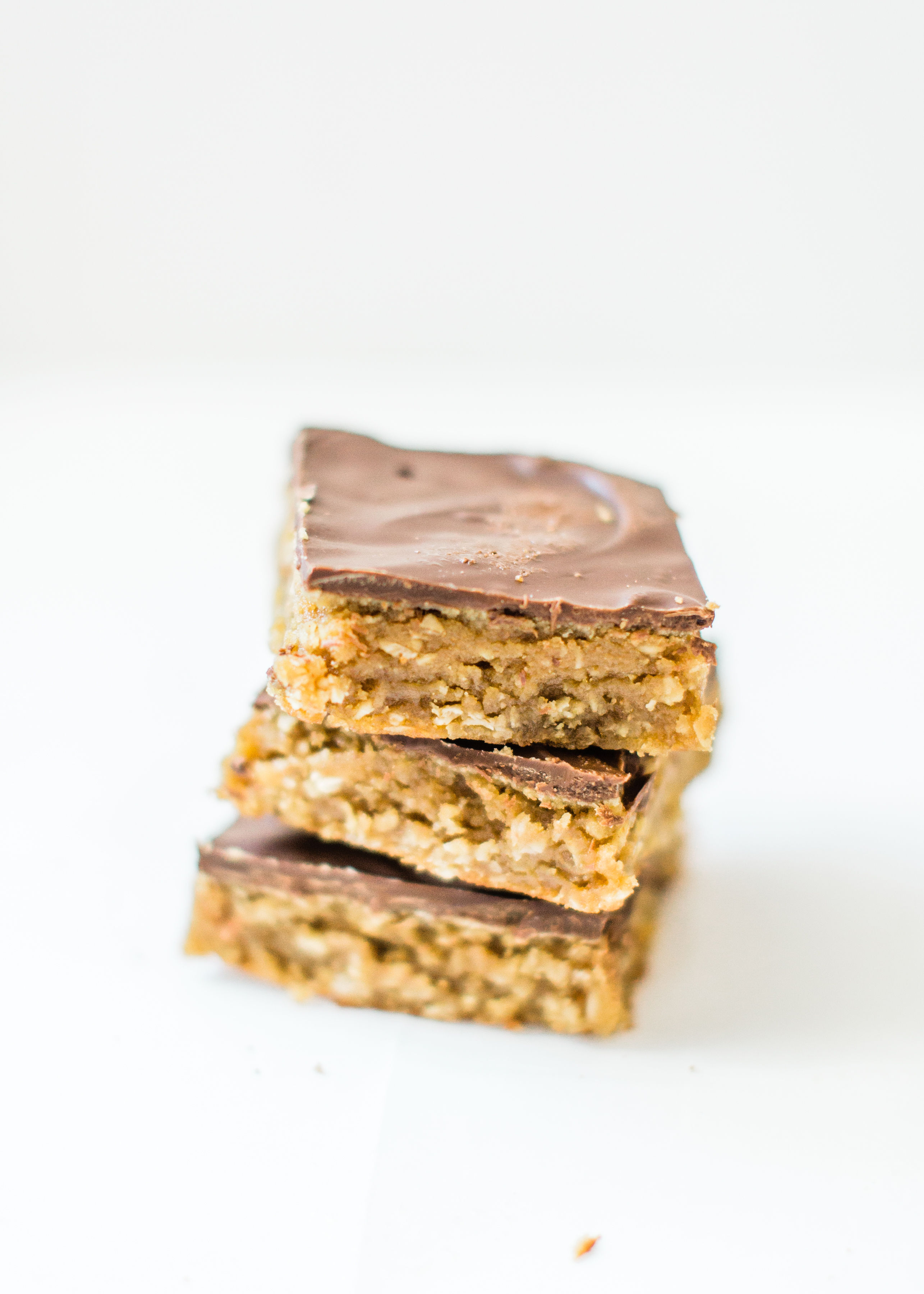 Sheet pan chocolate peanut butter oatmeal cookie bars are simple to whip up, incredibly yummy, and can easily feed a crowd. These easy cookies are a total fan favorite! Click through for the recipe. | glitterinc.com | @glitterinc