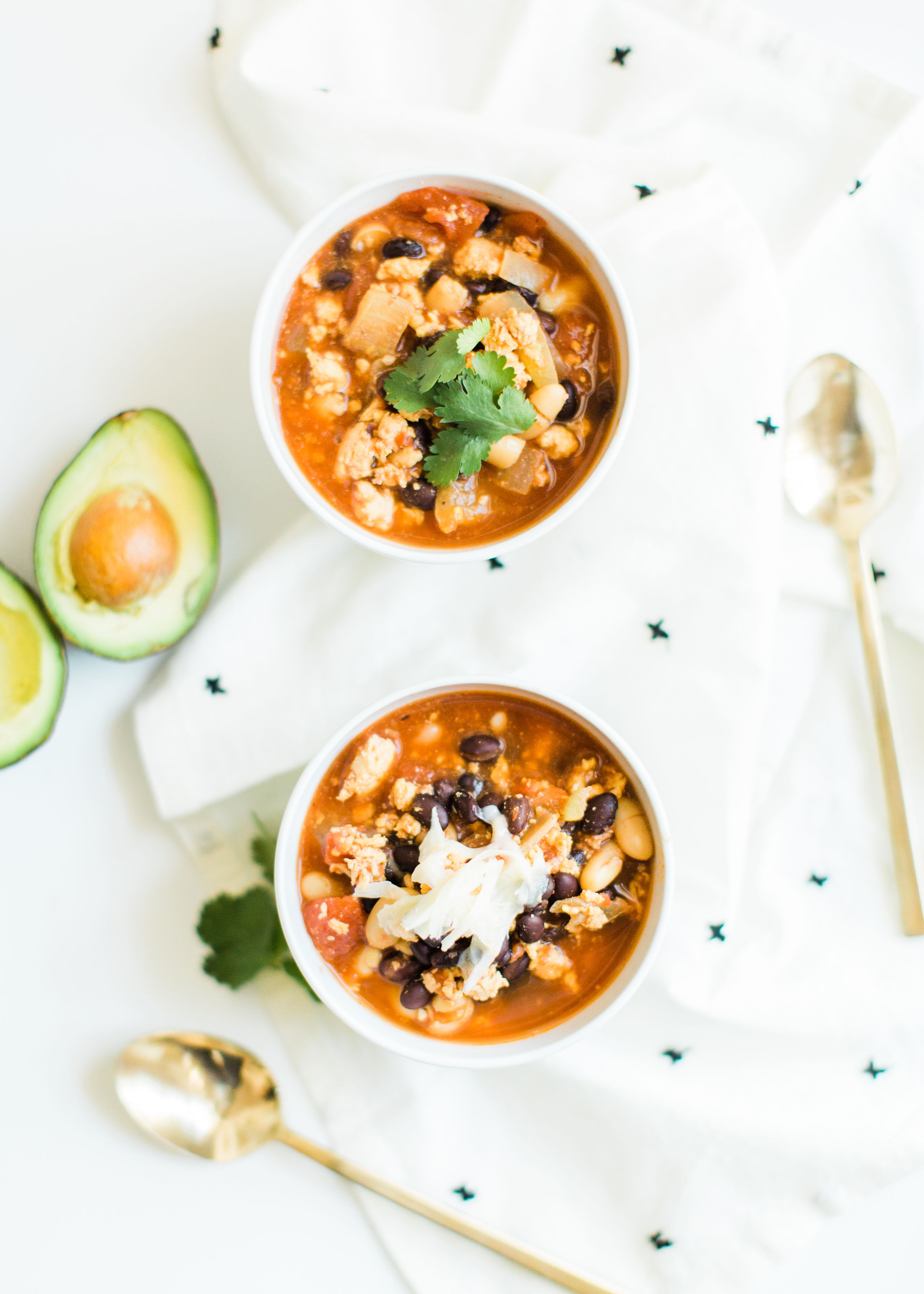 This easy and delicious ground chicken chili all comes together in an Instant Pot or crockpot. Serve this made ahead chili with yummy toppings and cornbread and enjoy an incredible, hearty, healthy, and simple meal. Click through for the recipe. | glitterinc.com | @glitterinc