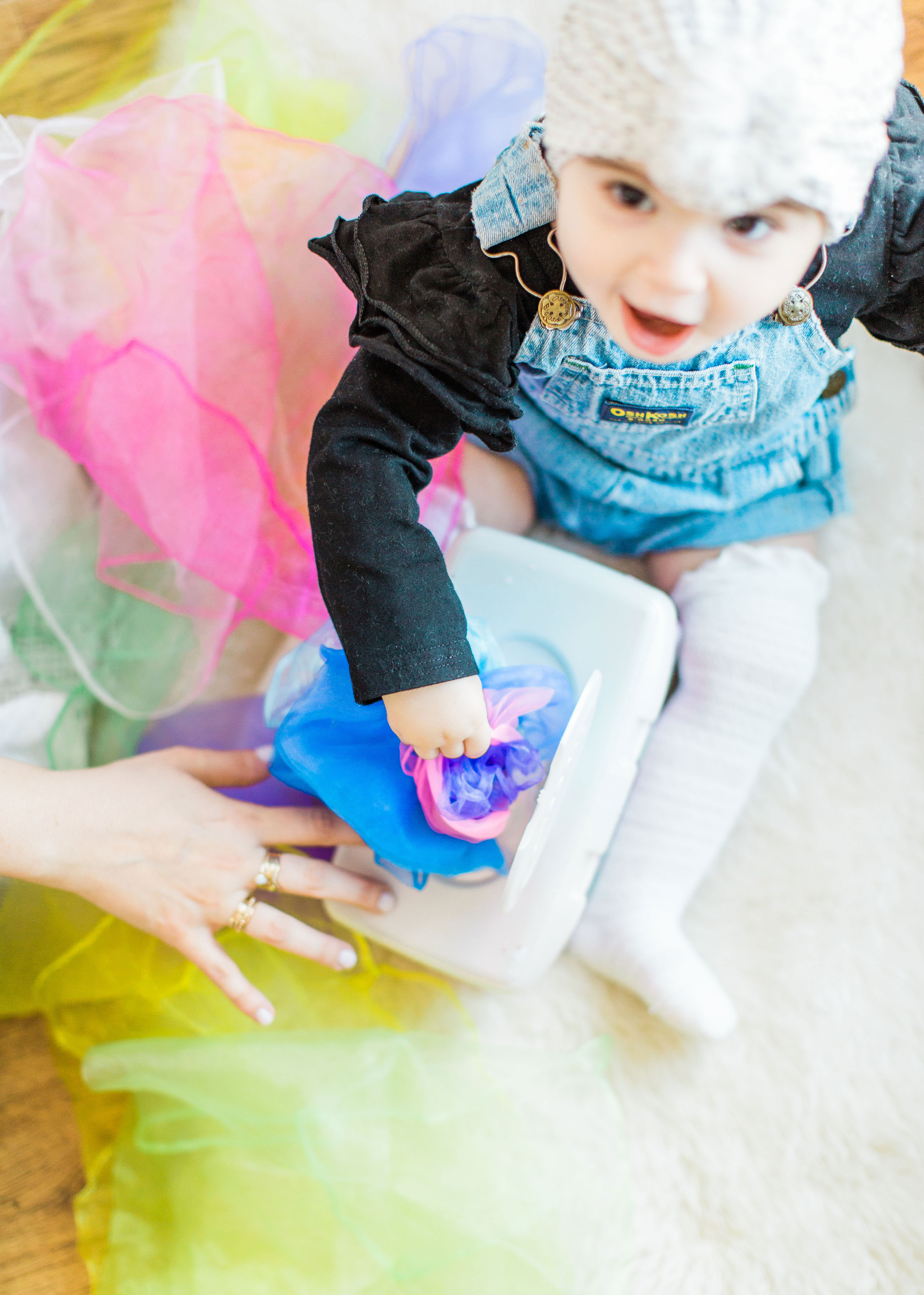 Make an easy, magic sensory toy using an empty wipes container and inexpensive colorful scarves. | Click through for the DIY. | glitterinc.com | @glitterinc