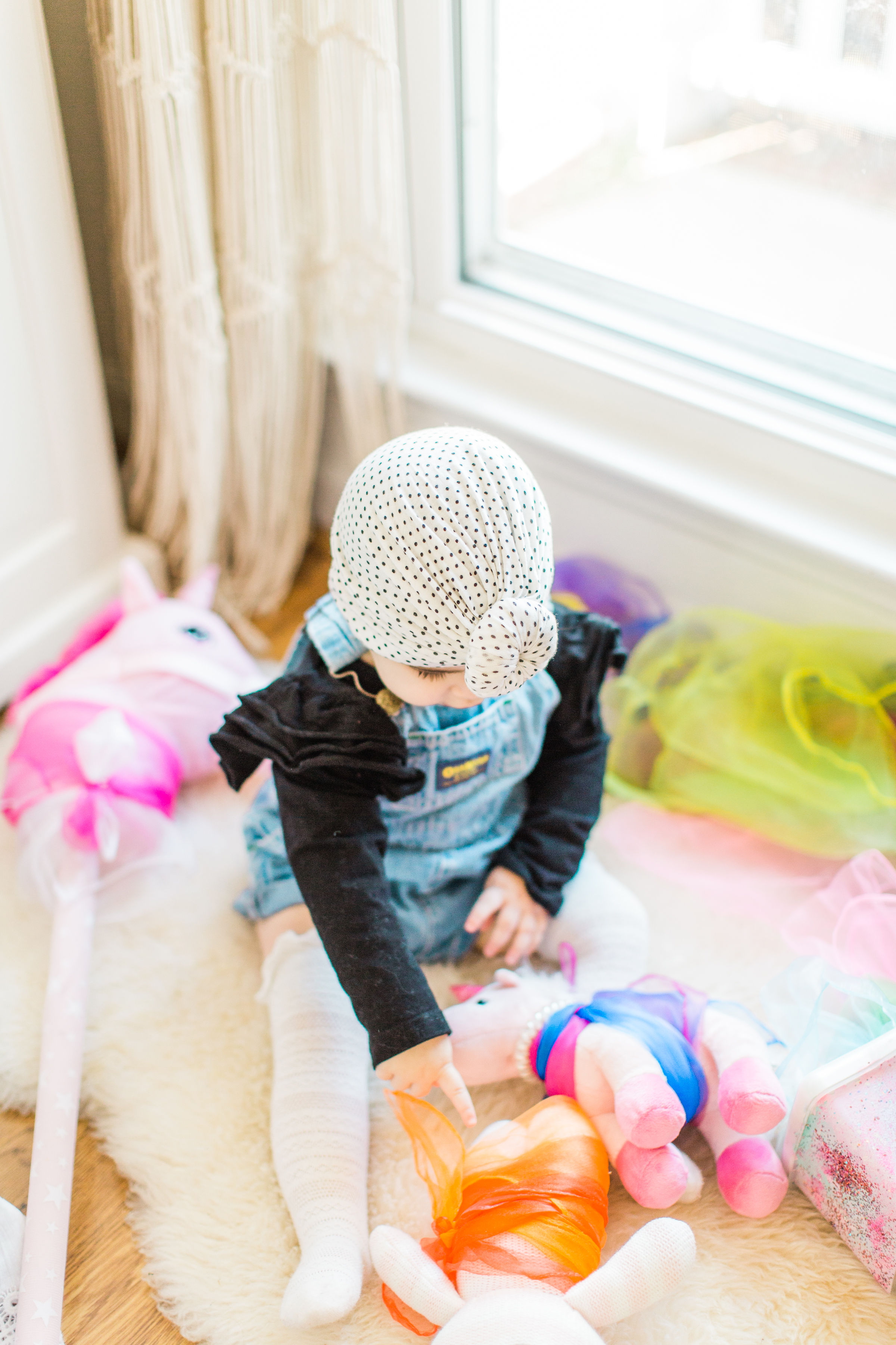 Looking for a fun activity to do with your baby? Make an easy, magic sensory toy using an empty wipes container and inexpensive colorful scarves. | Click through for the DIY. | glitterinc.com | 