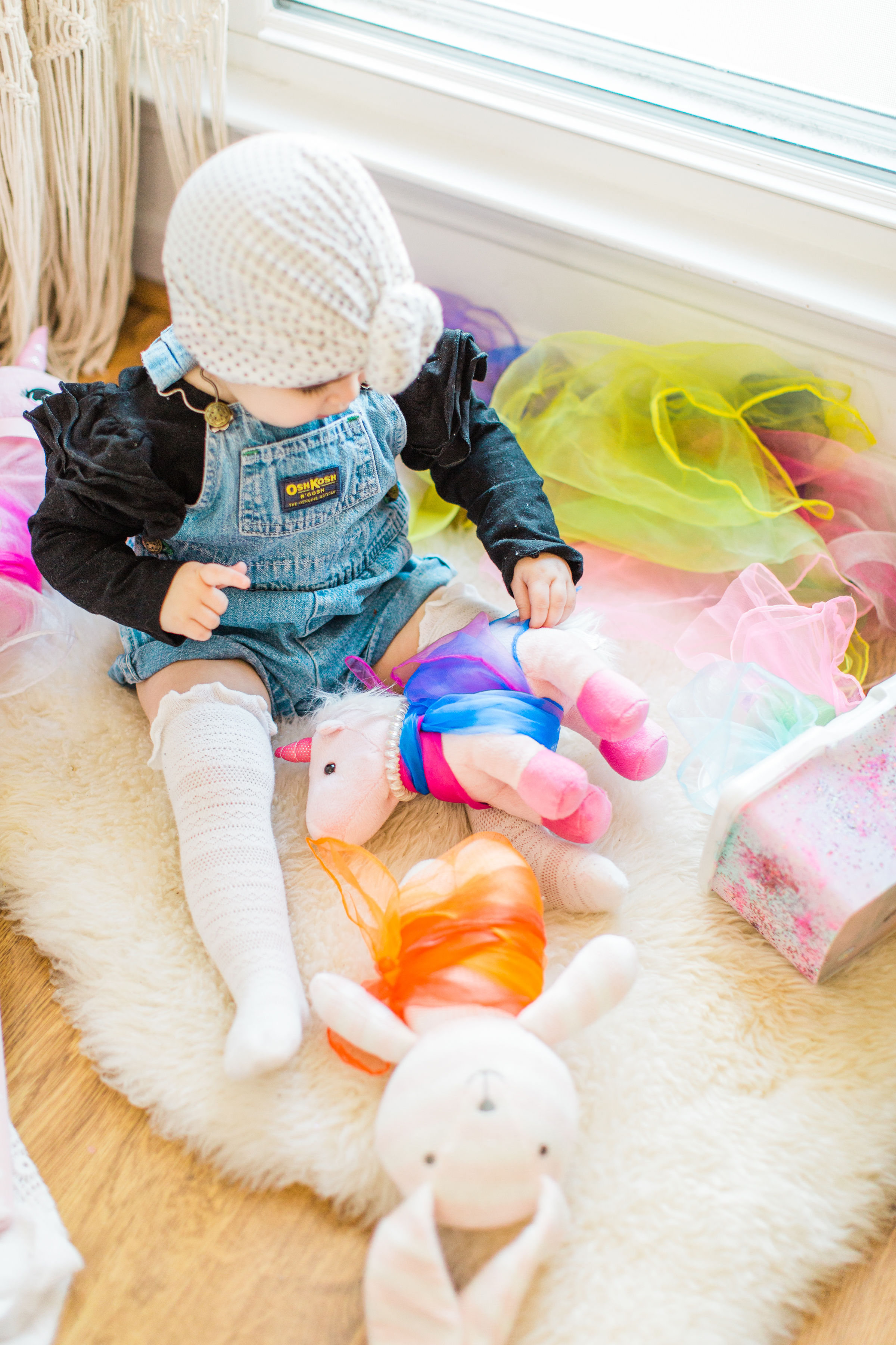 Looking for a fun activity to do with your baby? Make an easy, magic sensory toy using an empty wipes container and inexpensive colorful scarves. | Click through for the DIY. | glitterinc.com | @glitterinc