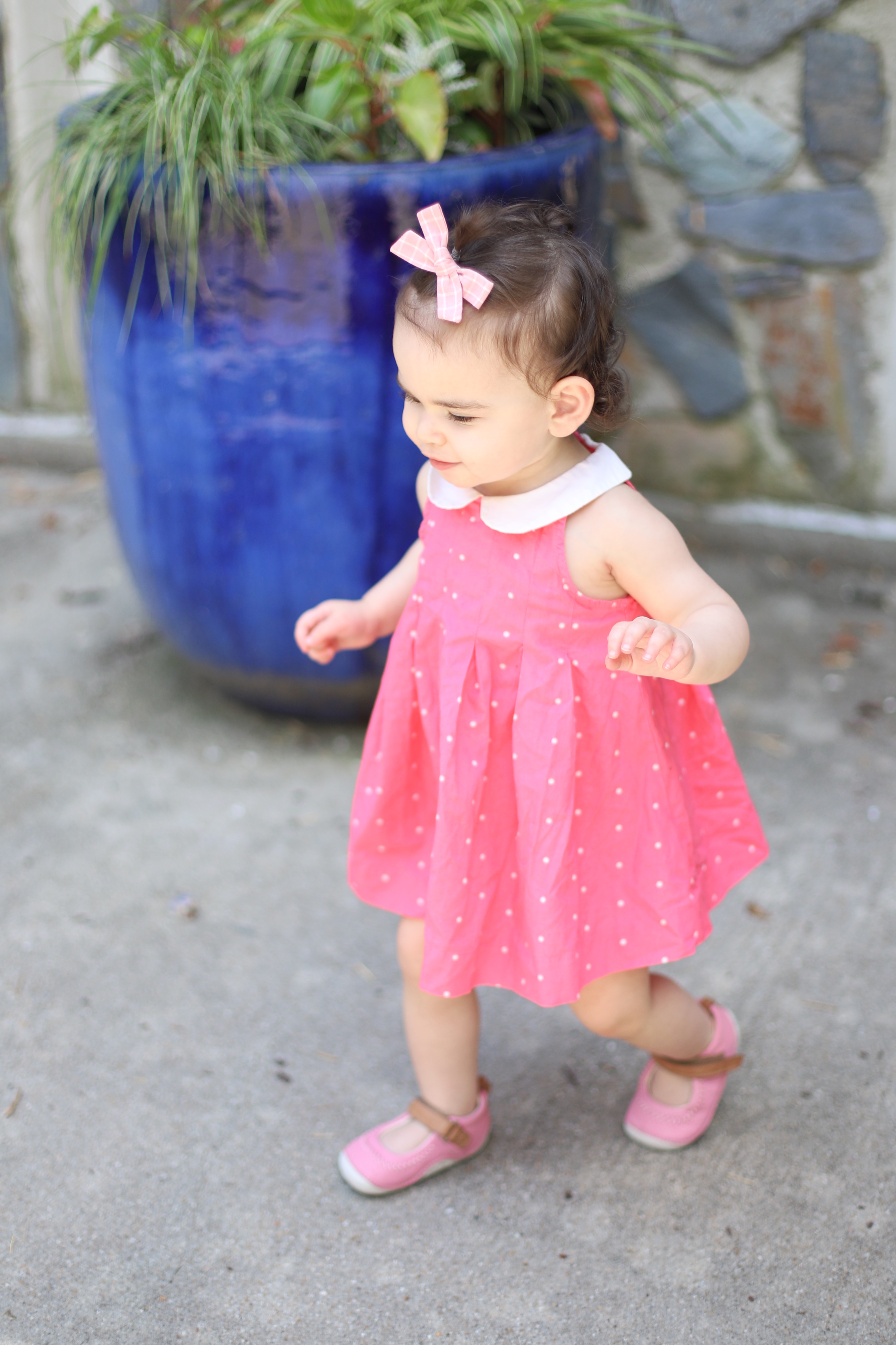 toddler girl is wearing a cute pink outfit