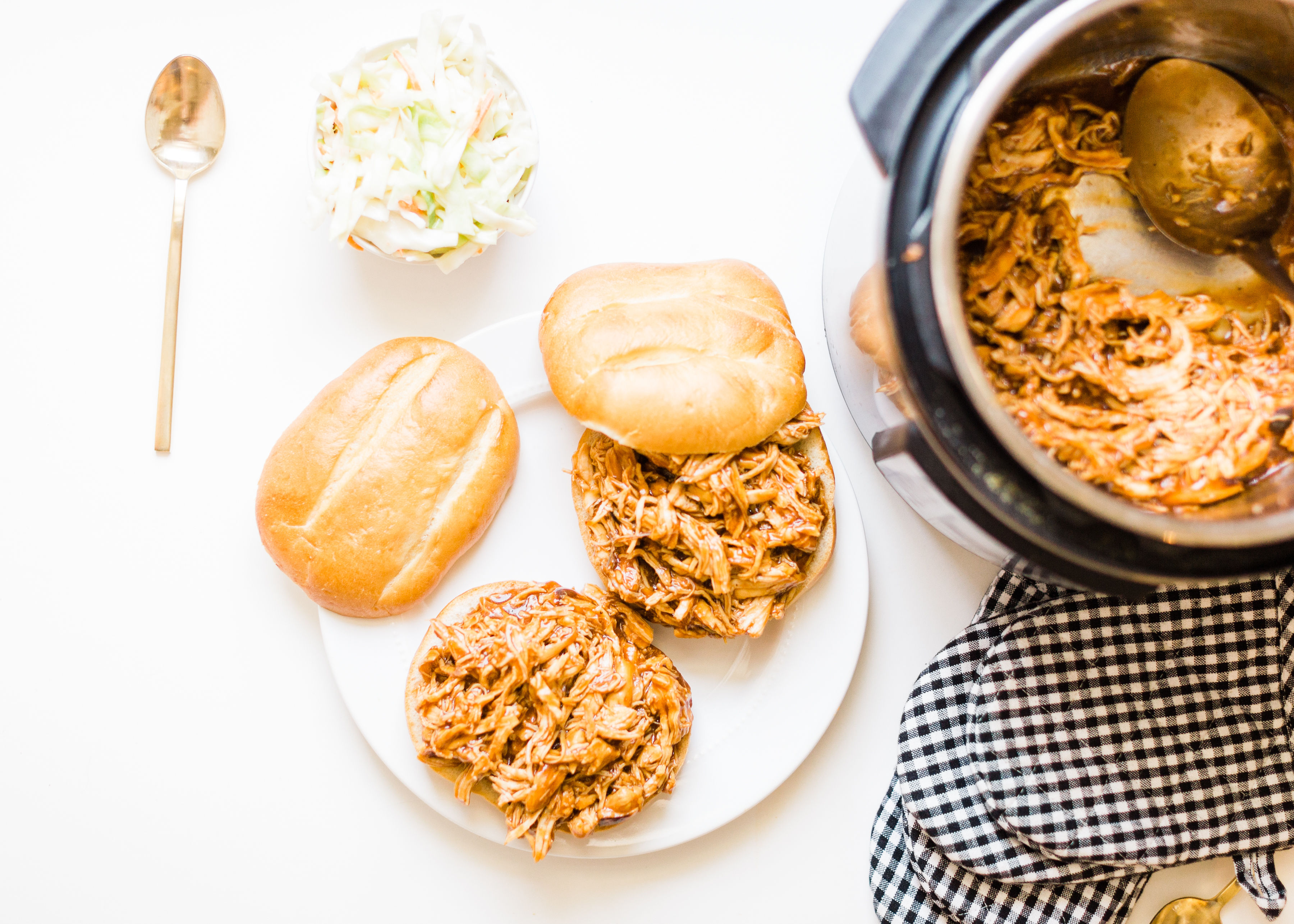 Skip the hot grill and make delicious barbecue pulled chicken in your slow cooker! Just throw a few ingredients right in the pot and let your crock pot or instant pot do the rest.  | glitterinc.com | @glitterinc