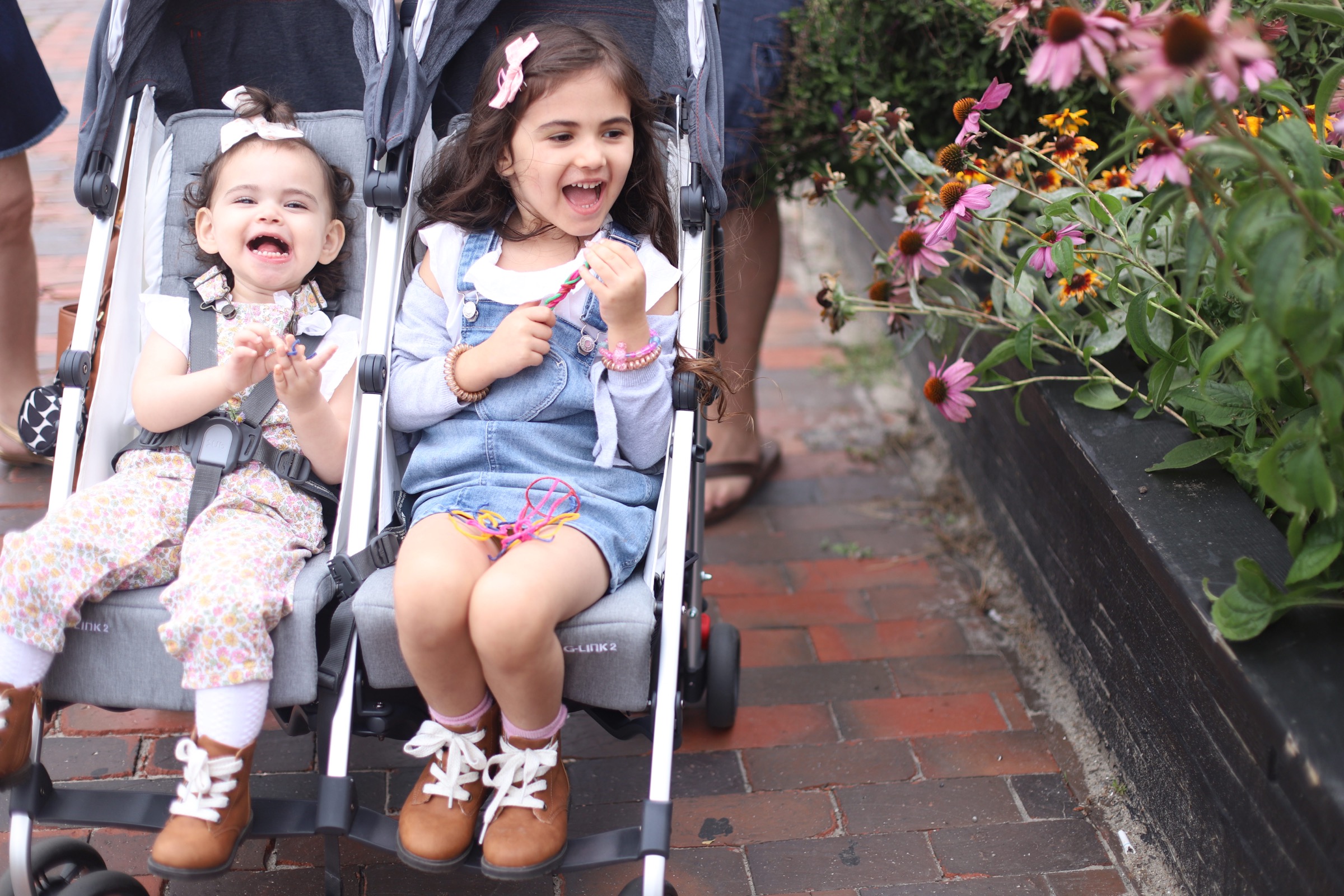 kids in a double stroller from UPPAbaby G-LINK 2 and why it’s the perfect double stroller for travel with two kidsa