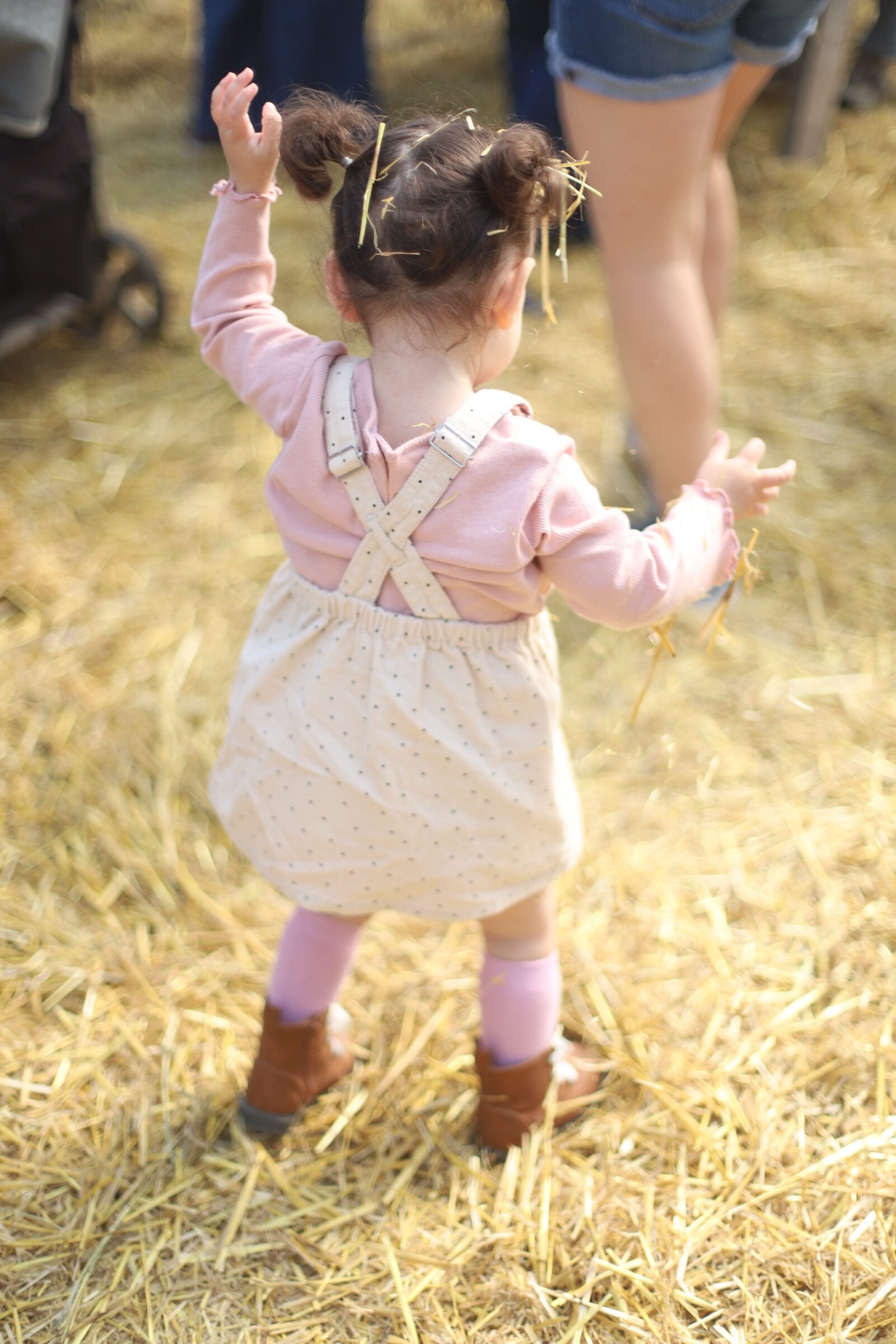 A little girl after playing with the haystack during a trip to an apple orchard here in New England, complete with apple picking, barnyard animals, hayrides, and homemade donuts and pie. // Brooksby Farm in Peabody, Massachusetts // Fall Bucket List | glitterinc.com | @glitterinc