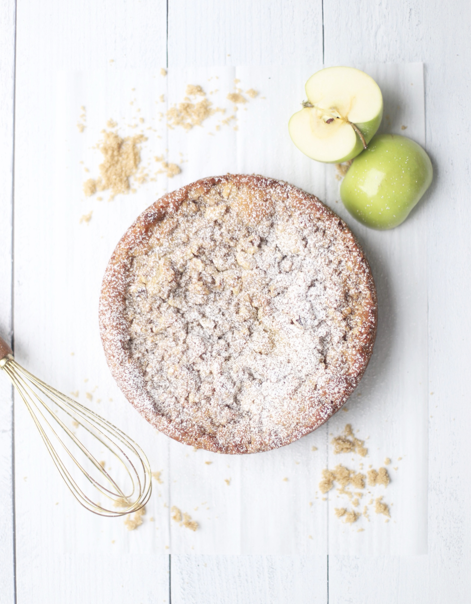 apple crumb cake topped with powdered sugar