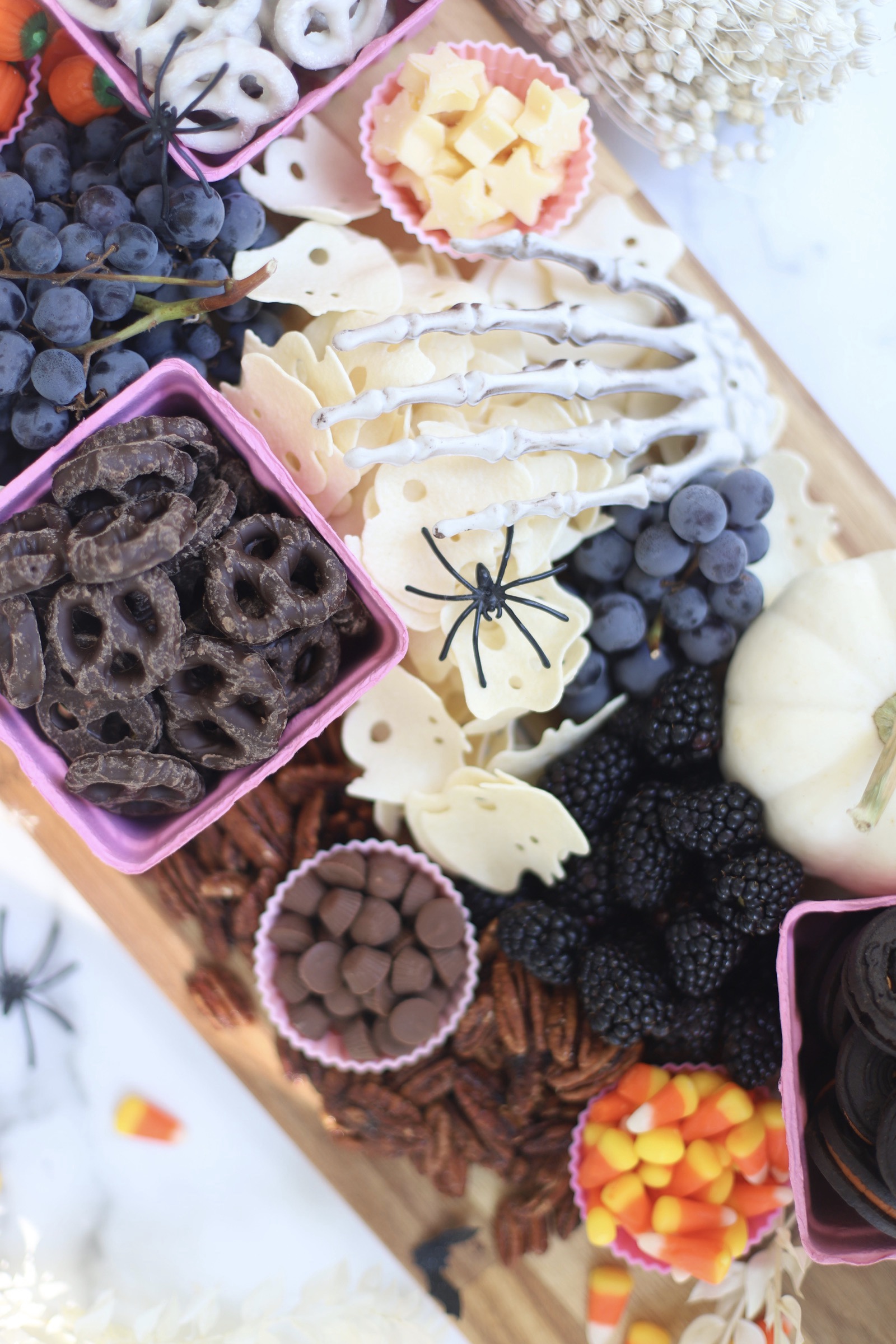 Serve a beautifully spooky Halloween charcuterie board chock full of snacks the whole family will love! This frightfully delicious snack board is perfect for Halloween celebrations, a no-fuss dinner after a night of trick-or-treating, even a festive afternoon snack throughout the month of October. Happy snacking! | glitterinc.com | @glitterinc