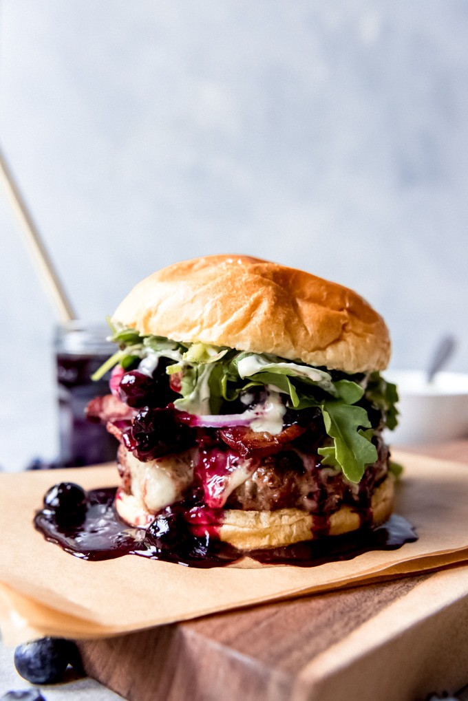 What better way to celebrate a big birthday than with a delicious, home cooked meal? Click through for 40 delicious birthday dinner ideas to celebrate that special someone at home. #recipes | glitterinc.com | @glitterinc // Red, White, and Blueberry Bacon Burger with Basil Aioli