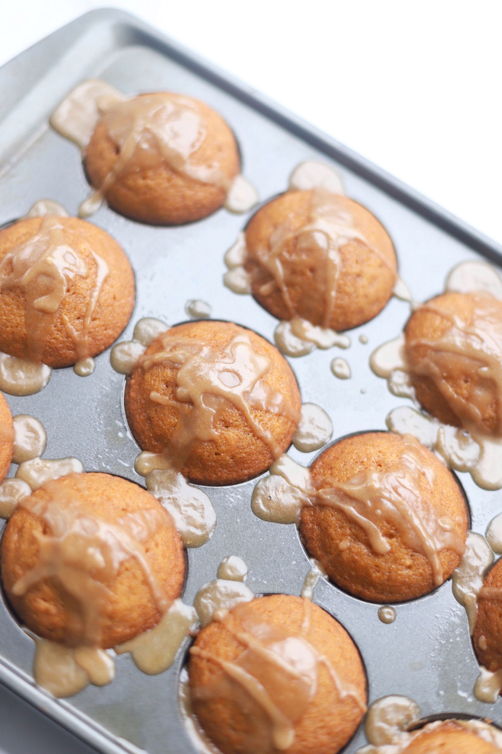 Say hello to the most incredible fluffy, moist, delicately sweet pumpkin muffins topped with my new favorite brown sugar cinnamon glaze. They can also easily be made dairy-free and gluten-free. | @glitterinclexi | GLITTERINC.COM