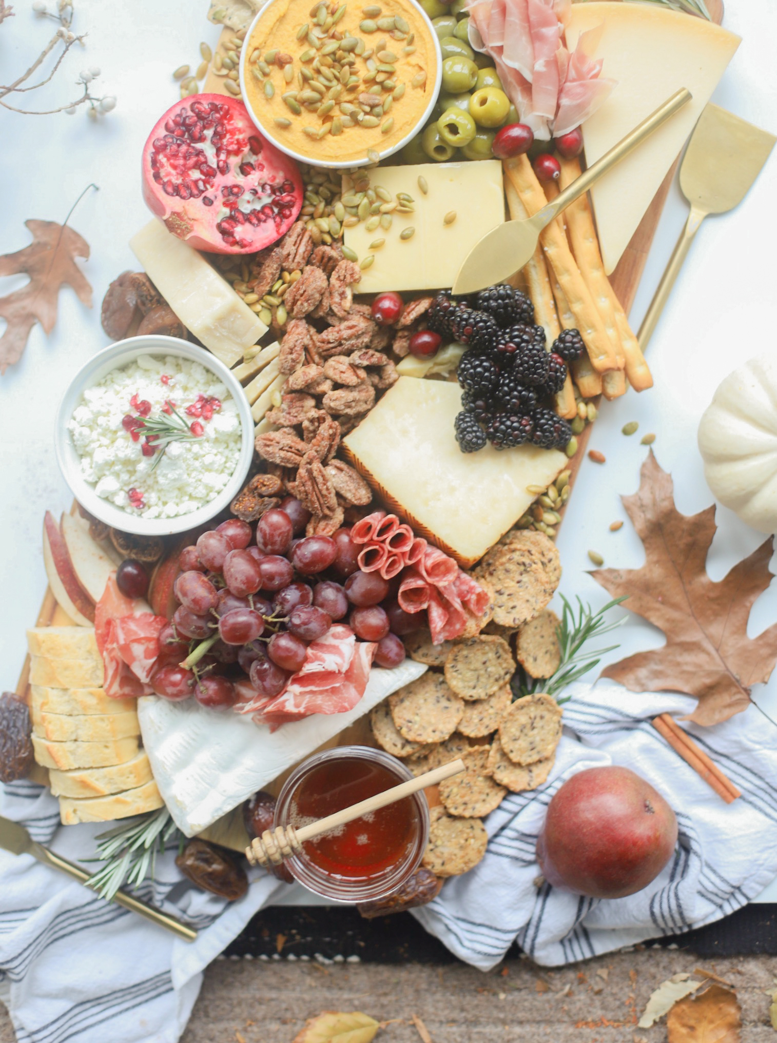 Putting together a big, beautiful charcuterie board is easier than you think. Make this impressive Thanksgiving cheese board for the fall holiday this year and seriously wow all of your guests! | glitterinc.com | @glitterinc