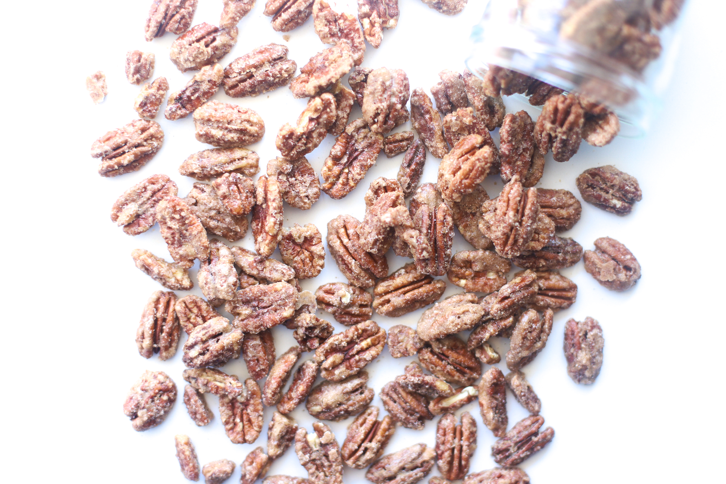 Candied Pecans are sweet, crunchy, and perfect for holiday parties and homemade gifts! These cinnamon-sugar roasted and spiced nuts are also super easy to make, especially in big batches. Click through for the recipe. | glitterinc.com | @glitterinc