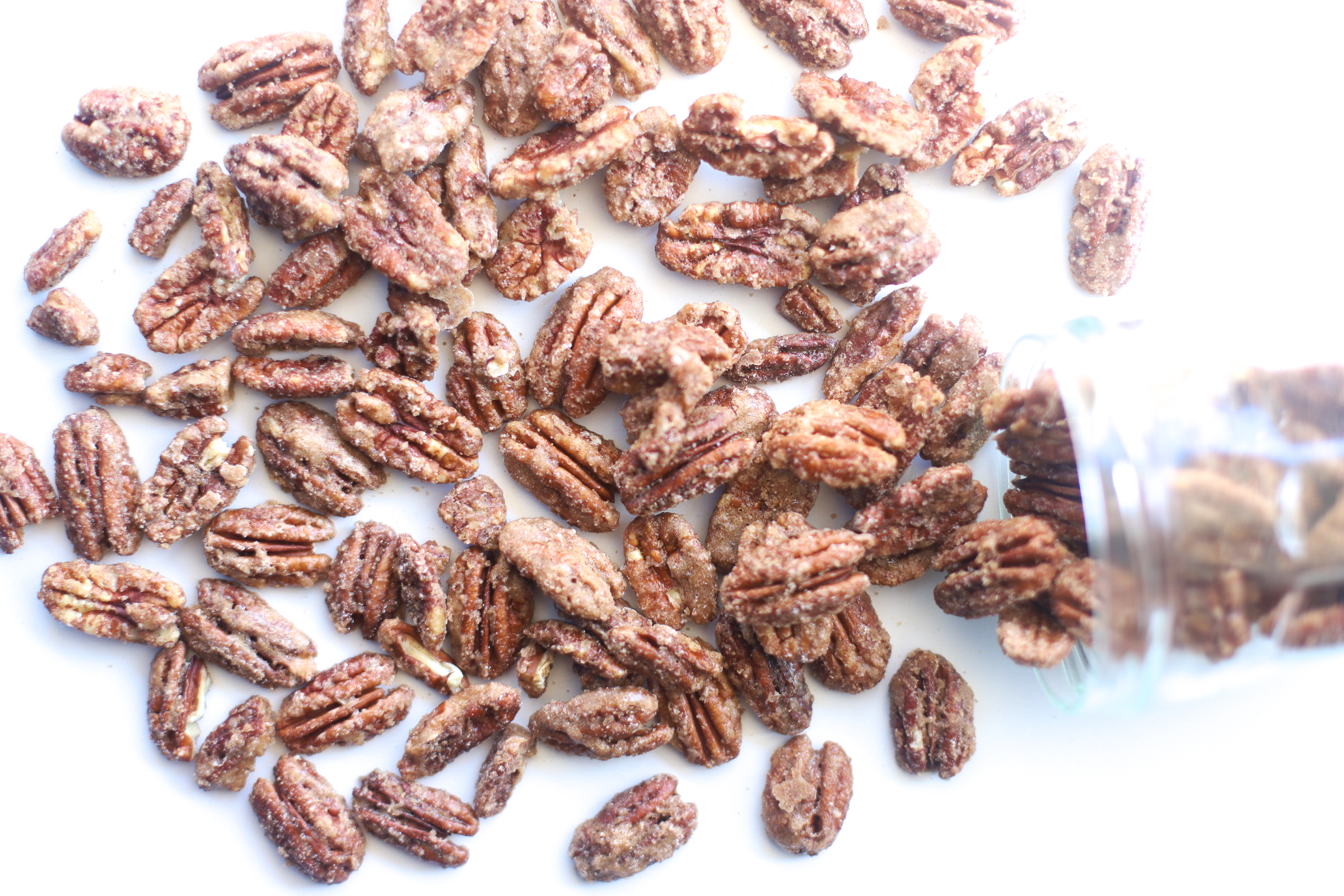 Candied Pecans are sweet, crunchy, and perfect for holiday parties and homemade gifts! These cinnamon-sugar roasted and spiced nuts are also super easy to make, especially in big batches. Click through for the recipe. | glitterinc.com | @glitterinc