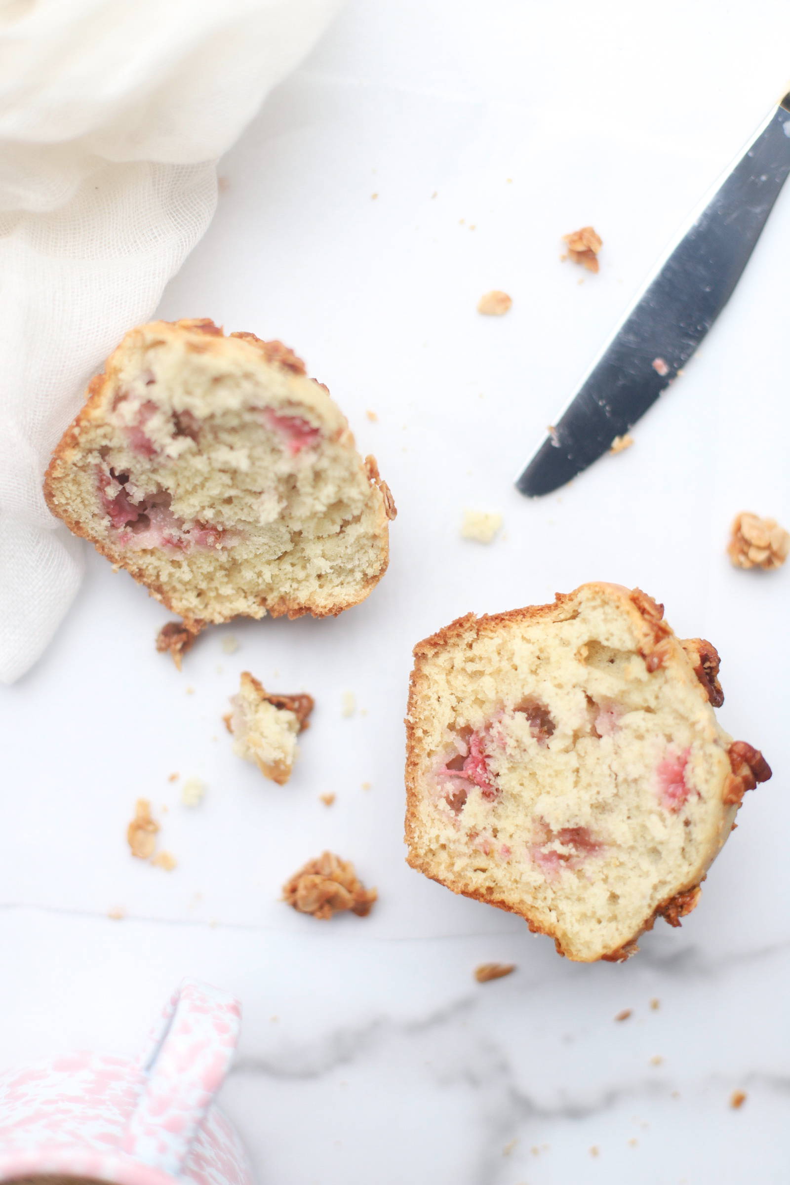 Bake up a batch of these decadently fluffy and moist bakery-style Strawberry Yogurt Granola Crumble Muffins, made with rich Greek yogurt, full of fresh strawberry flavor, and topped with our favorite homemade classic granola crumble. Click through for the recipe. | glitterinc.com | @glitterinc