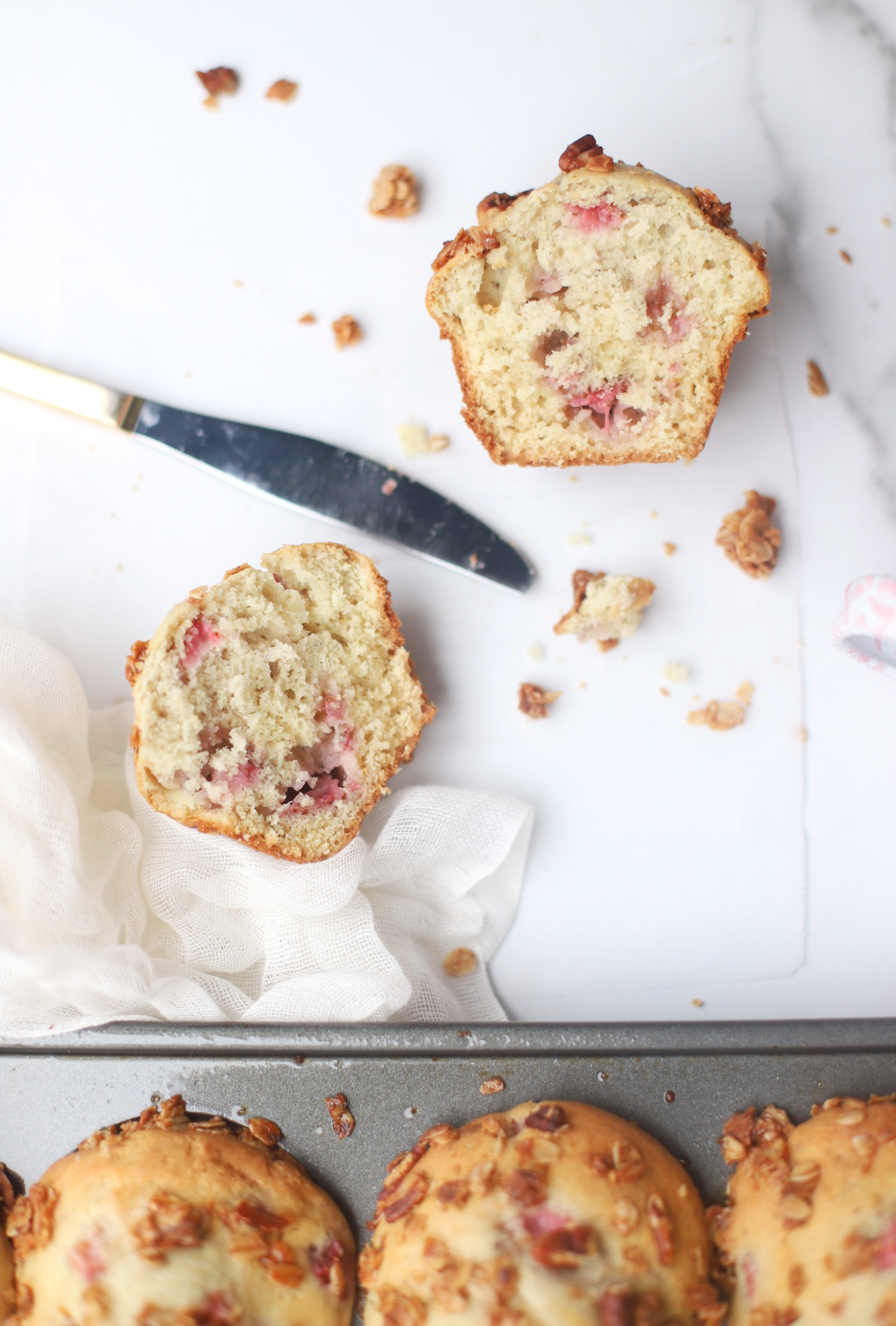 Bake up a batch of these decadently fluffy and moist bakery-style Strawberry Yogurt Granola Crumble Muffins, made with rich Greek yogurt, full of fresh strawberry flavor, and topped with our favorite homemade classic granola crumble. Click through for the recipe. | glitterinc.com | @glitterinc