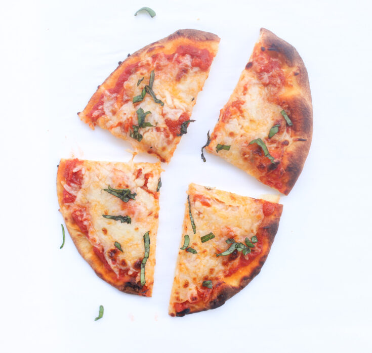 Our Favorite 10-Minute Naan Bread Pizza bakes up with a crispy, golden crust, is topped with tomato sauce and bubbly cheese, and is so easy to put together. The whole family loves making and eating these delicious simple at-home pizzas! Click through for the recipe. | glitterinc.com | @glitterinc