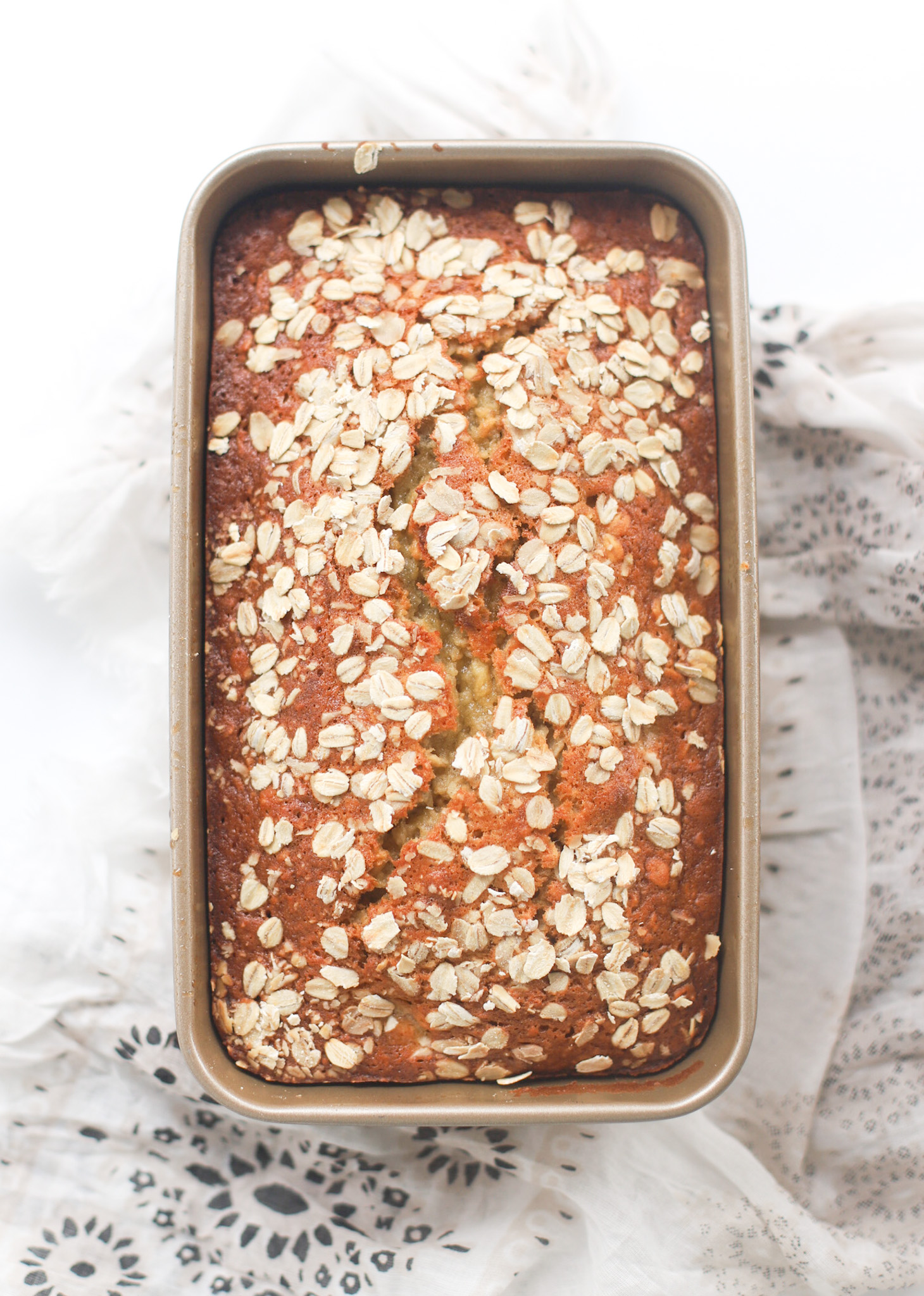 Oatmeal banana bread is the most amazing twist on a more classic banana quick bread. Filled with oats and yogurt, the recipe results in a delicious banana bread that is fluffy, moist, and has the perfect chewy crust. Click through for the recipe. | glitterinc.com | @glitterinc