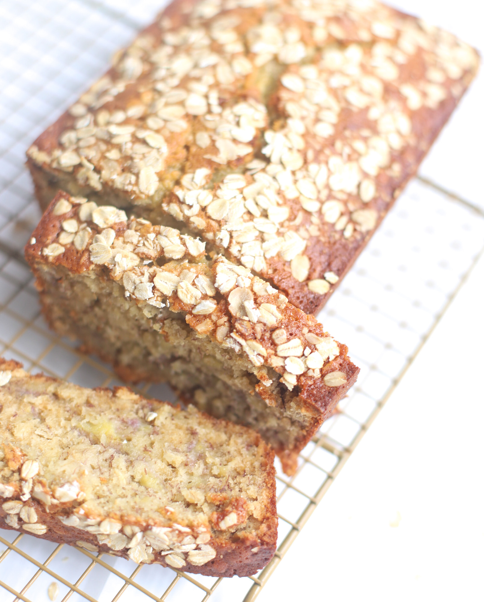 Oatmeal banana bread is the most amazing twist on a more classic banana quick bread. Filled with oats and yogurt, the recipe results in a delicious banana bread that is fluffy, moist, and has the perfect chewy crust. Click through for the recipe. | glitterinc.com | @glitterinc