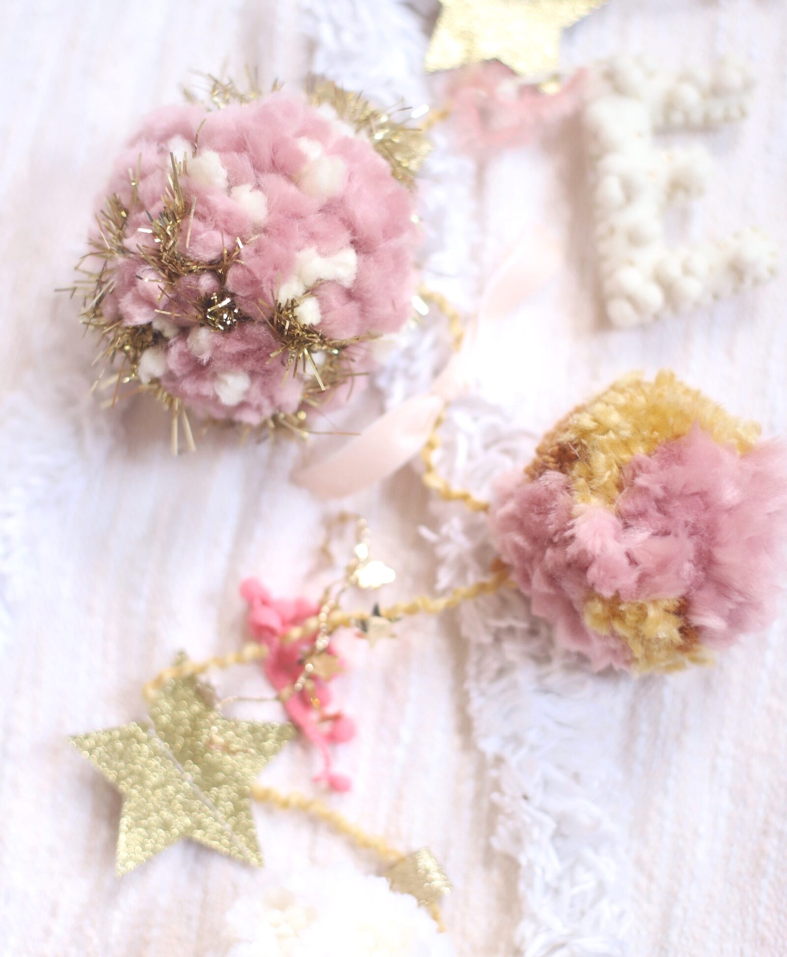 Make your own boutique-worthy DIY festive tinsel, ribbon, and glitter stars pom pom garland; a.k.a., a glammed up pom pom garland with a whole lot of pizazz.| @glitterinclexi | GLITTERINC.COM