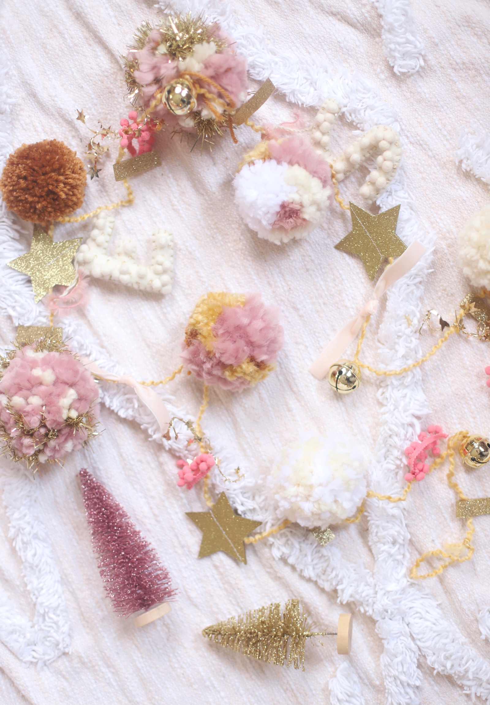 Make your own boutique-worthy DIY festive tinsel, ribbon, and glitter stars pom pom garland; a.k.a., a glammed up pom pom garland with a whole lot of pizazz.| @glitterinclexi | GLITTERINC.COM