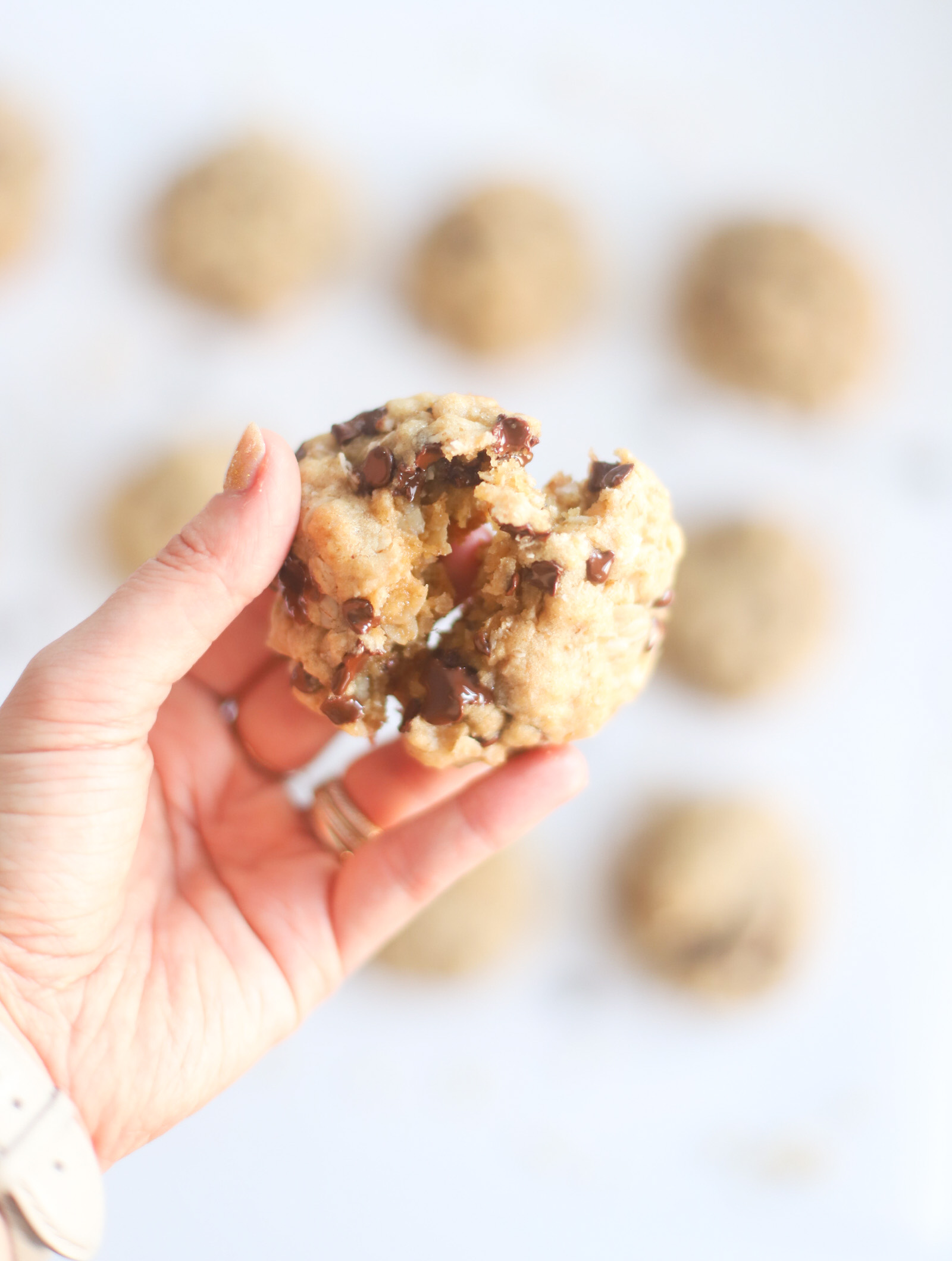 Hands down our very favorite oatmeal chocolate chip cookies, these heavenly oatmeal cookies are moist in the center, crisp and chewy on the outside, and totally delicious. They’re also super easy to make all in one bowl, and can easily be made dairy-free, vegan, or gluten-free! | @glitterinclexi | GLITTERINC.COM