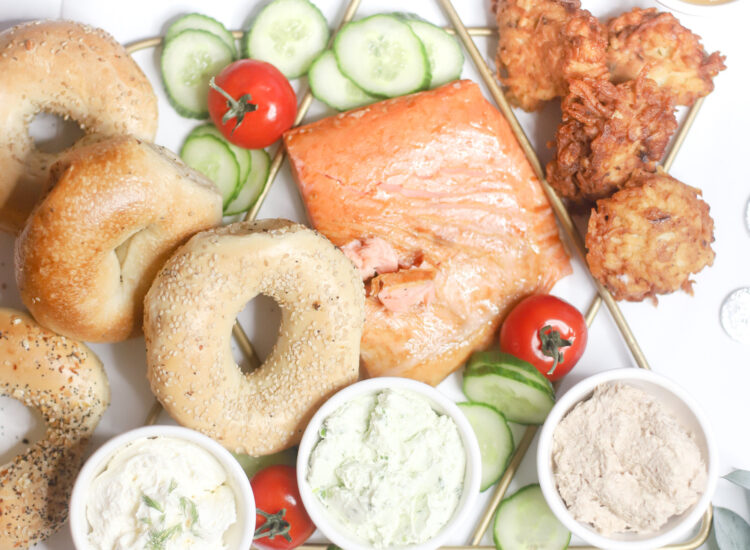 Celebrating Hanukkah this year? Make an easy and festive Chanukah dinner charcuterie complete with a simple board of bagels, smoked fish, latkes, and all of the fixings. | @glitterinclexi | GLITTERINC.COM