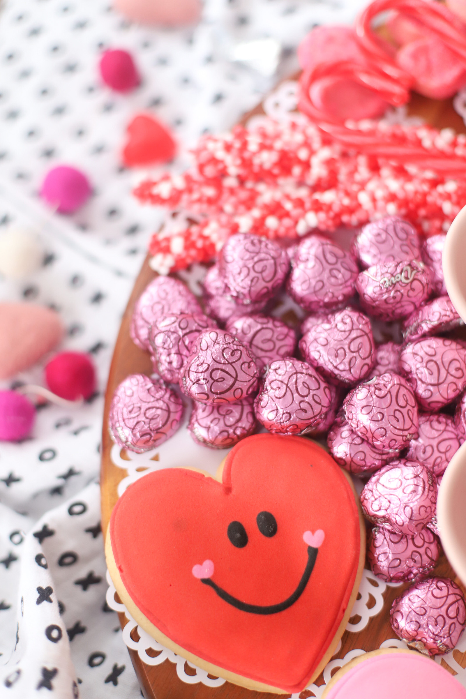 The Valentine’s Day dessert board is a spin on the traditional charcuterie, only this spread features nothing but dessert! Piled high with chocolates, candies, and cookies, this is the dessert spread of your sweet tooth dreams. No cooking required! | @glitterinclexi | GLITTERINC.COM