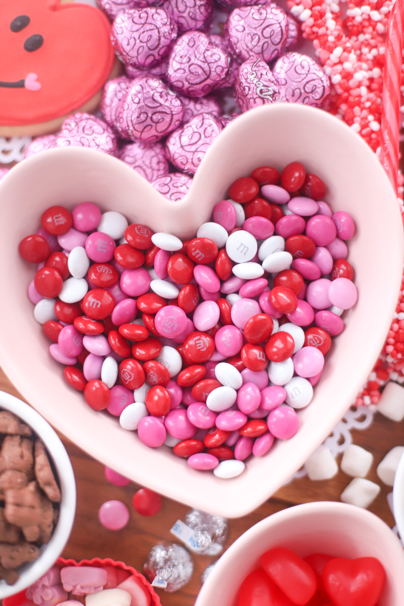 The Valentine’s Day dessert board is a spin on the traditional charcuterie, only this spread features nothing but dessert! Piled high with chocolates, candies, and cookies, this is the dessert spread of your sweet tooth dreams. No cooking required! | @glitterinclexi | GLITTERINC.COM