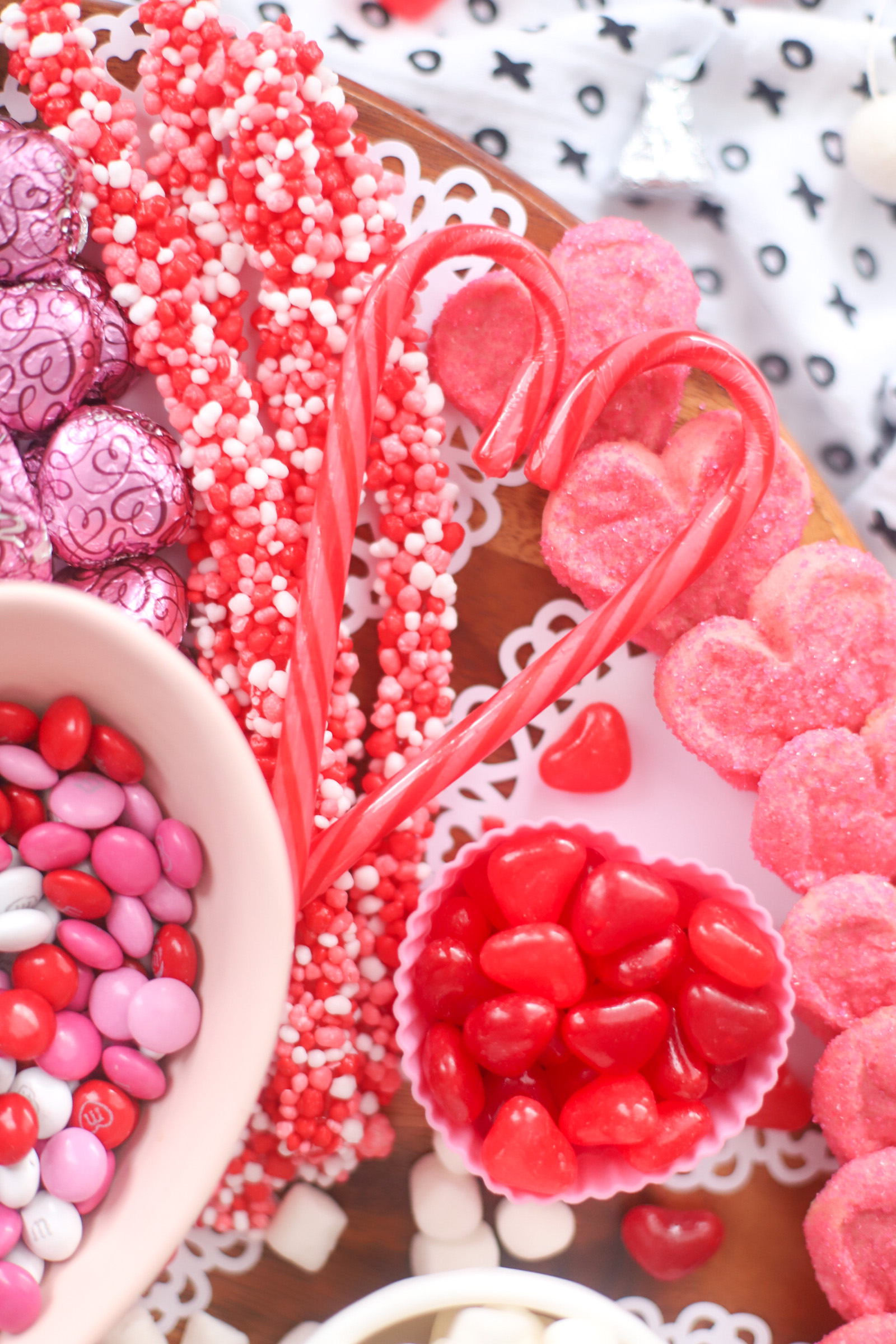 The Valentine’s Day dessert board is a spin on the traditional charcuterie, only this spread features nothing but dessert! Piled high with chocolates, candies, and cookies, this is the dessert spread of your sweet tooth dreams. No cooking required! | @glitterinclexi | GLITTERINC.COM