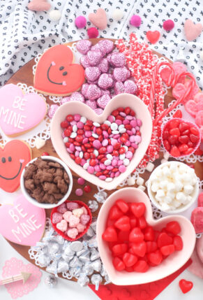 The Valentine’s Day dessert board is a spin on the traditional charcuterie, only this spread features nothing but dessert! Piled high with chocolates, candies, and cookies, this is the dessert spread of your sweet tooth dreams. No cooking required! | @glitterinclexi | GLITTERINC.COM