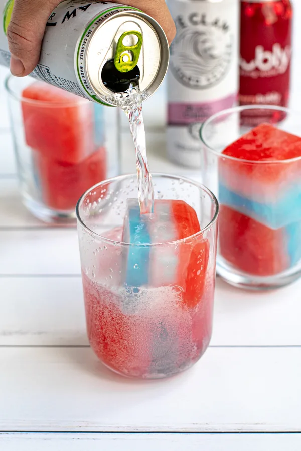 person pouring drink on Patriotic Red, White, and Blue Ice Cubes for the 4th of July