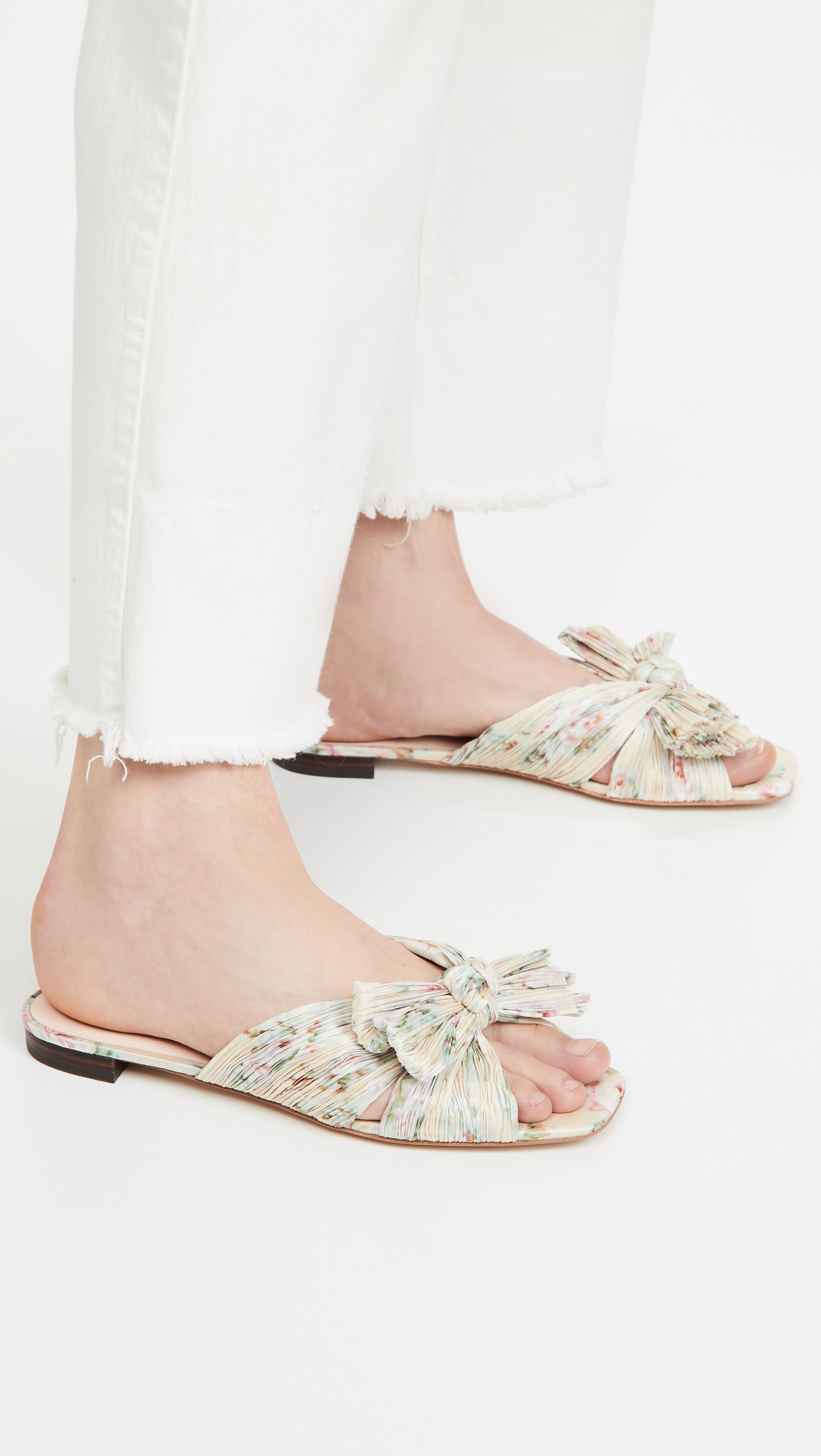 woman wearing Loeffler Randall Daphne Flat Sandals and white jeans