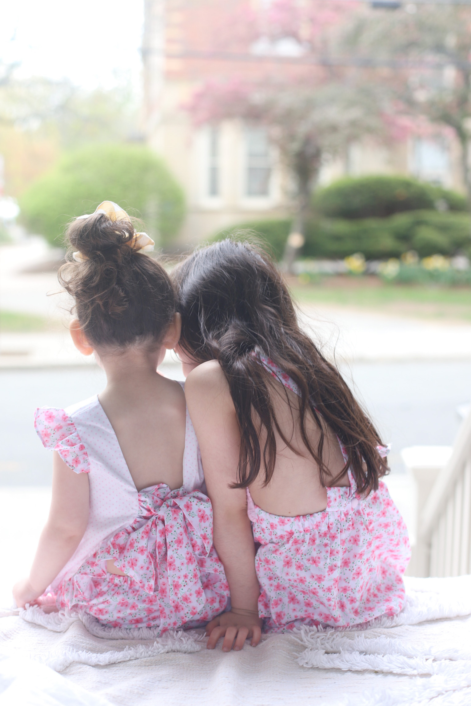 back of two kids facing the streets