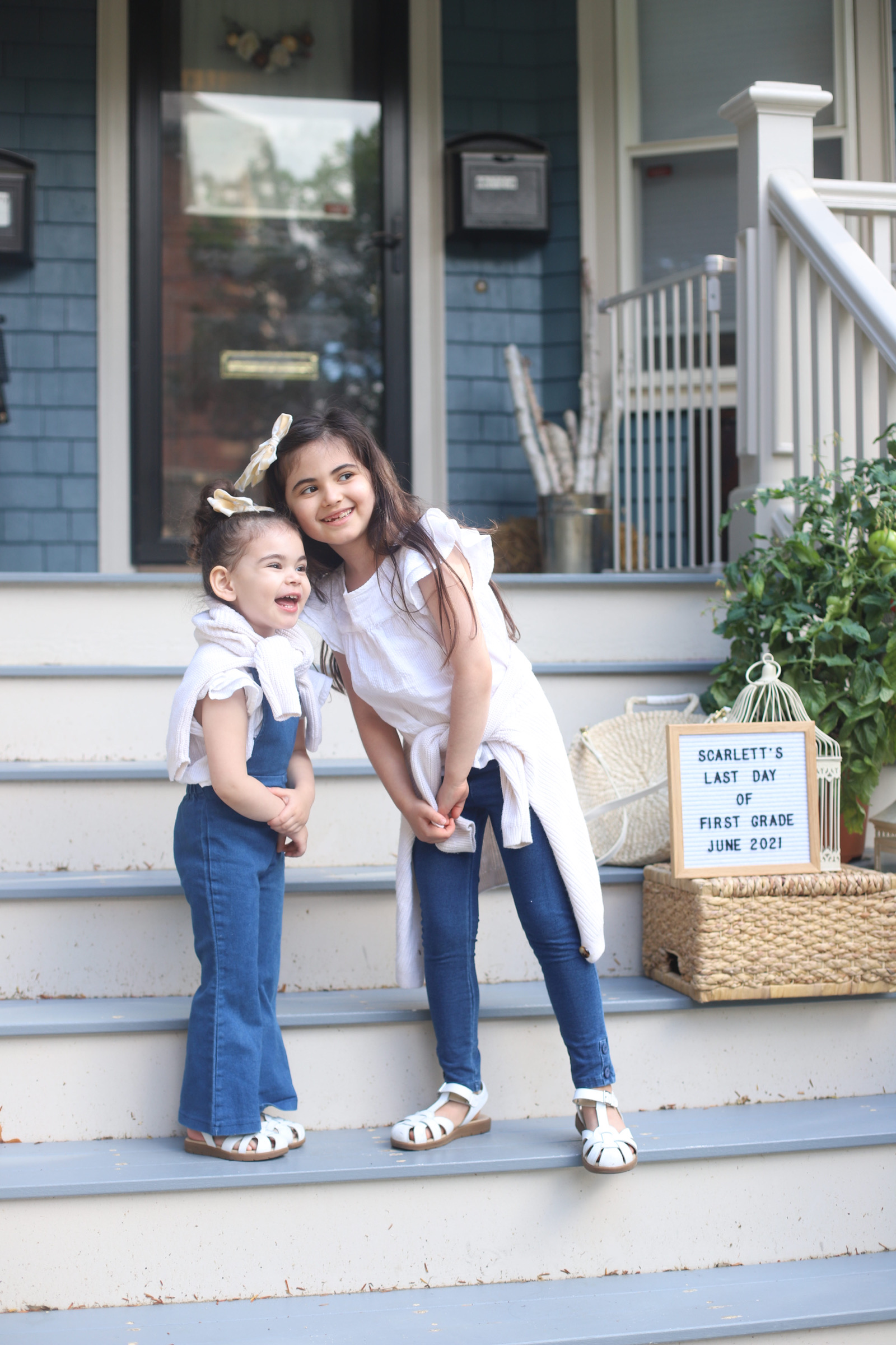 two kids outside their home because School's Out for Summer 