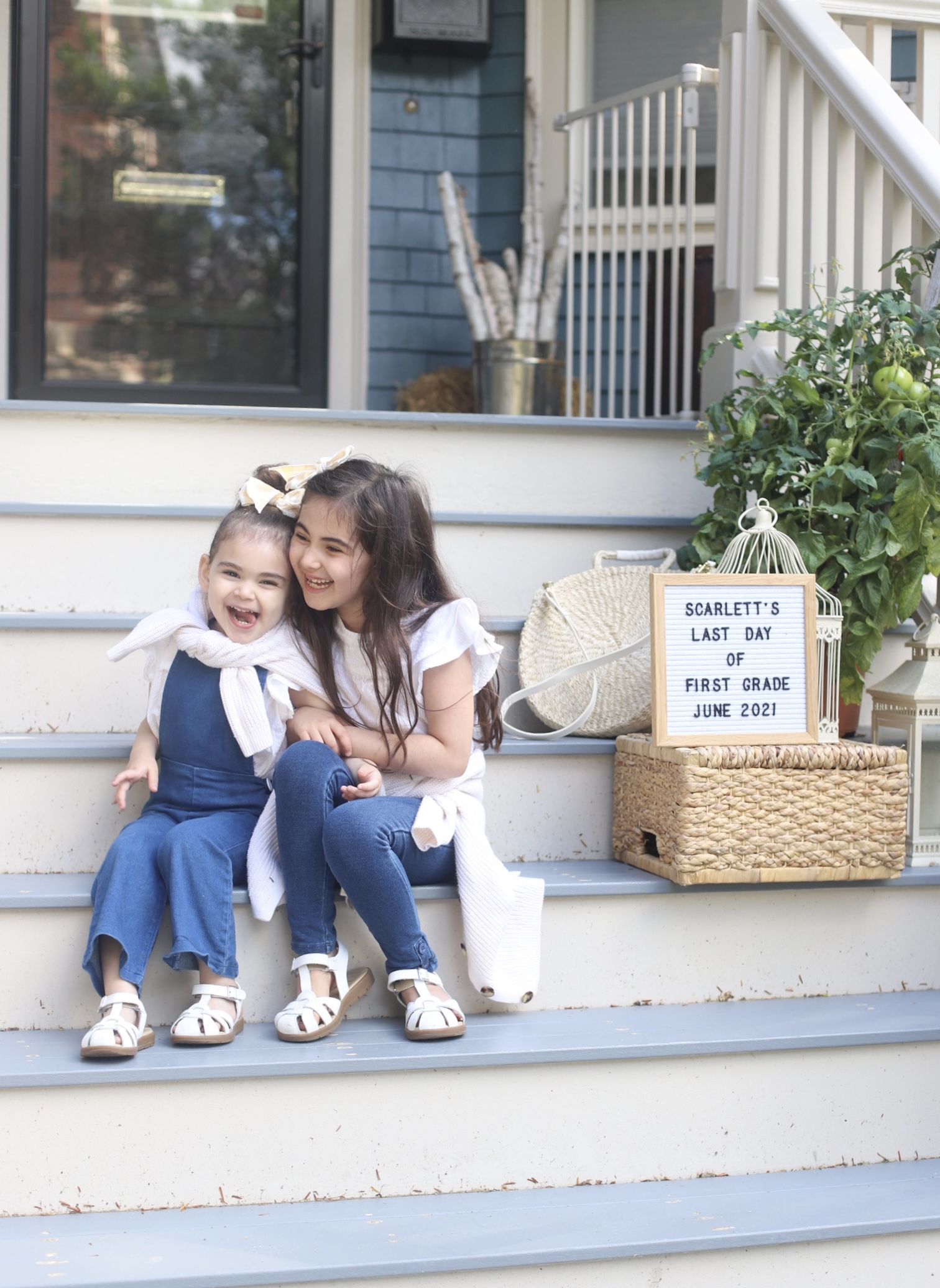 two kids sitting on the stairs outside because School's Out for Summer 