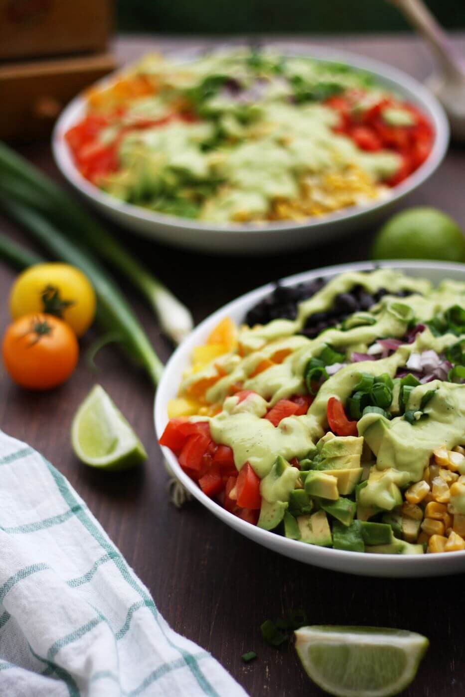 ingredients of Vegan Mexican Chopped Salad with Avocado Dressing on white plates 