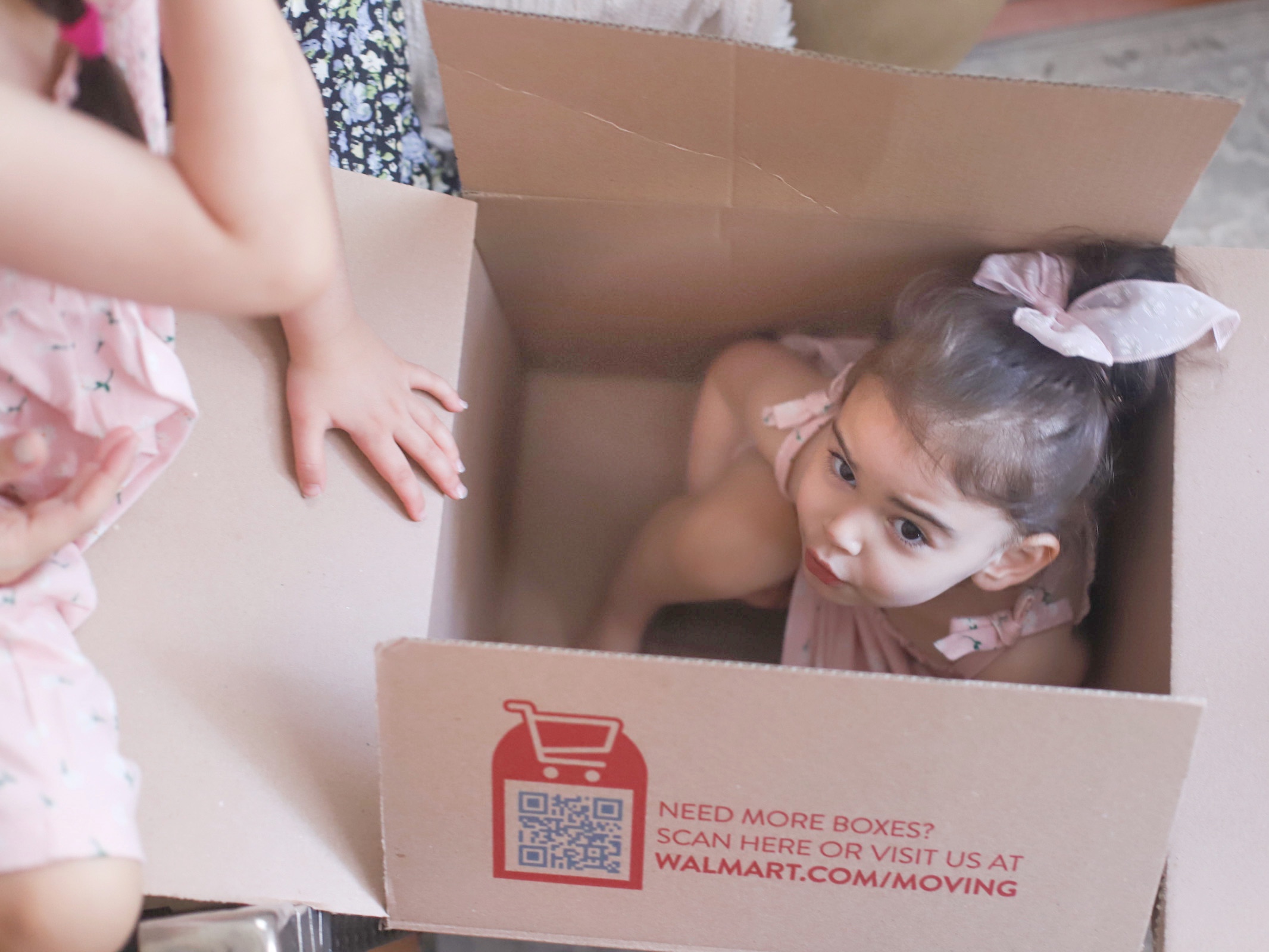 a child inside sitting inside a box for We Bought a House in Boston post