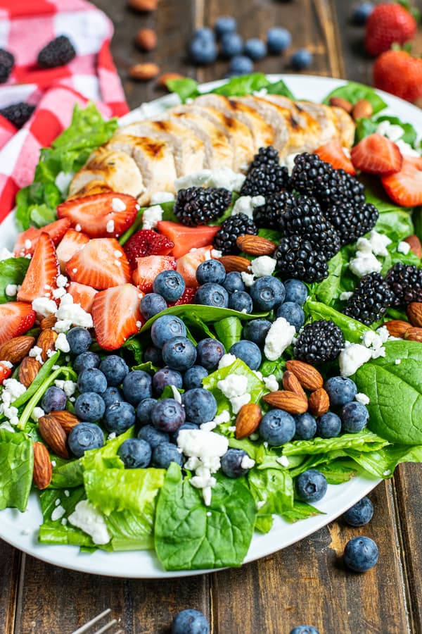 Summer Berry Grilled Chicken Salad on white plate for Incredible Summer Salad Recipes