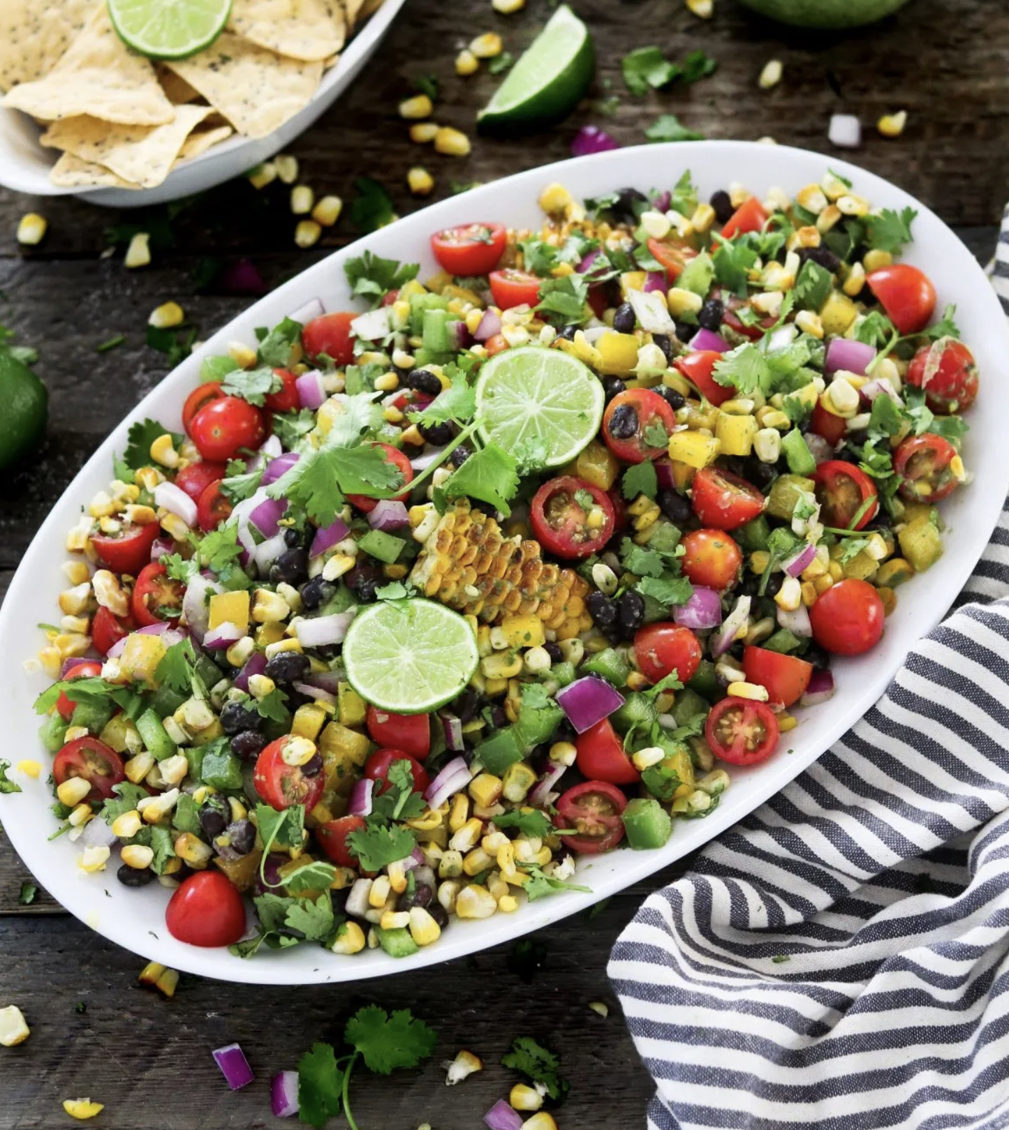 SUMMER GRILLED CORN SALAD W/ CILANTRO LIME DRESSING on a white serving plate