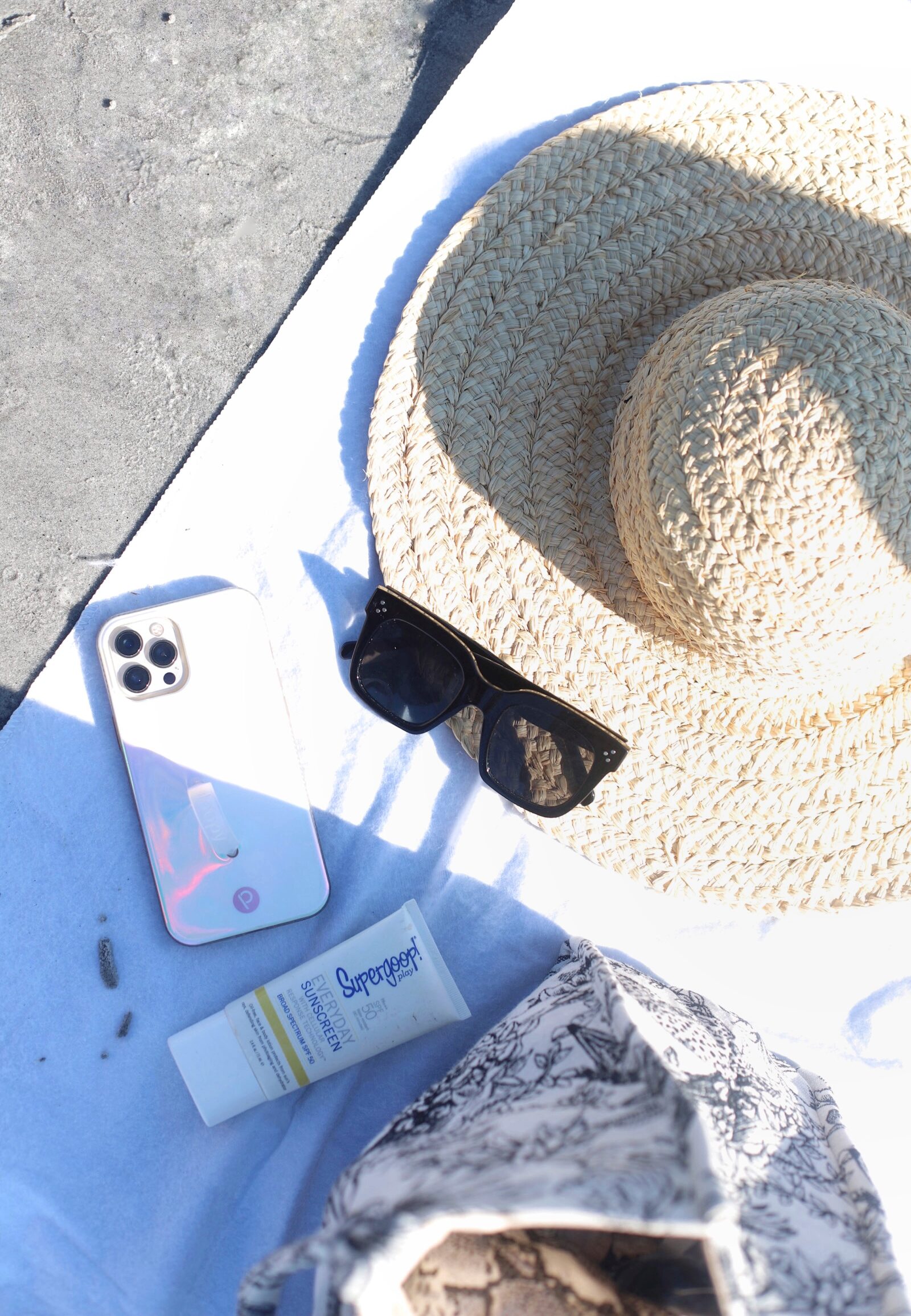 straw hat, favorite sunglasses from Amazon, sunblock, and phone 