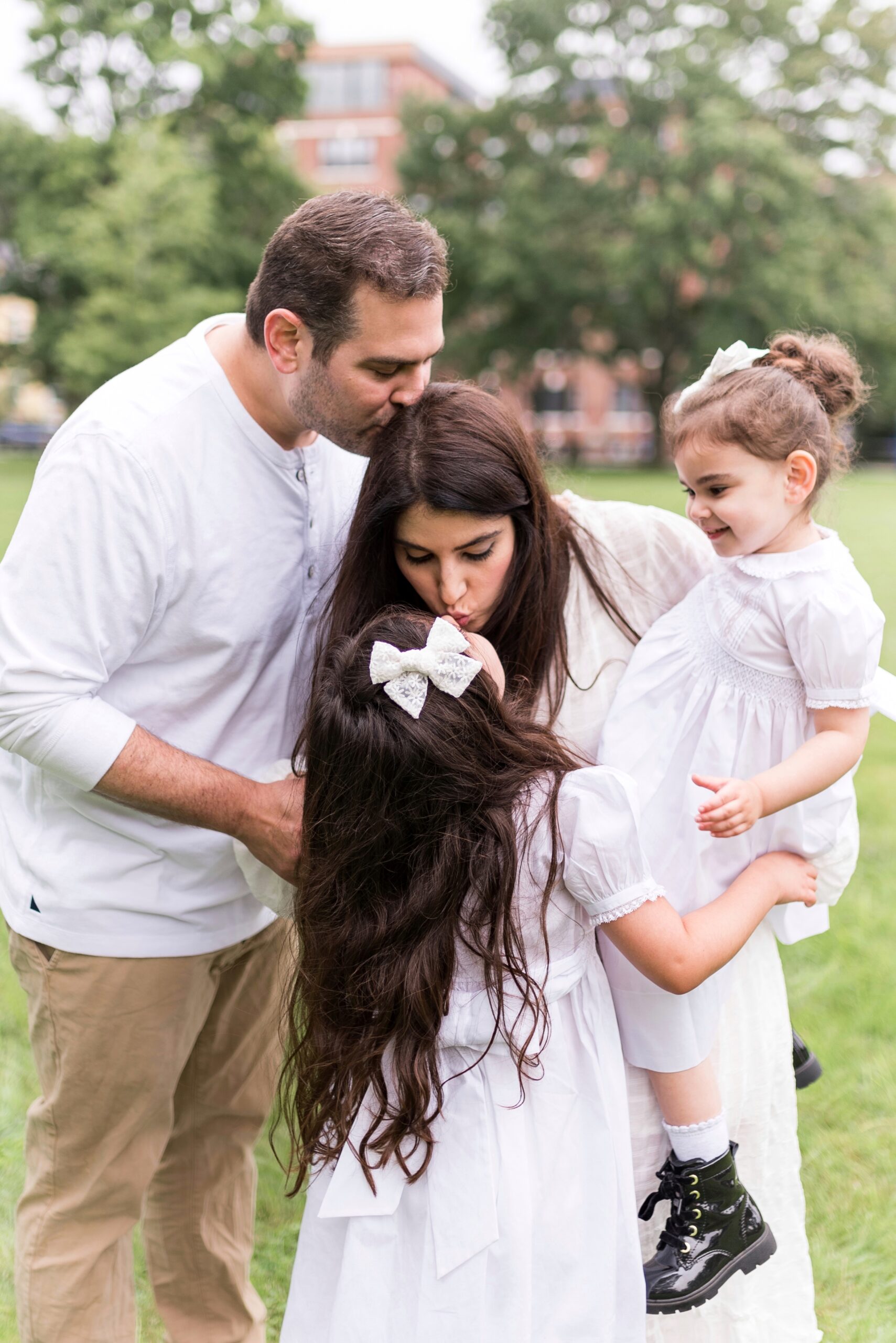 family in the outdoors and sharing We're Pregnant announcement 