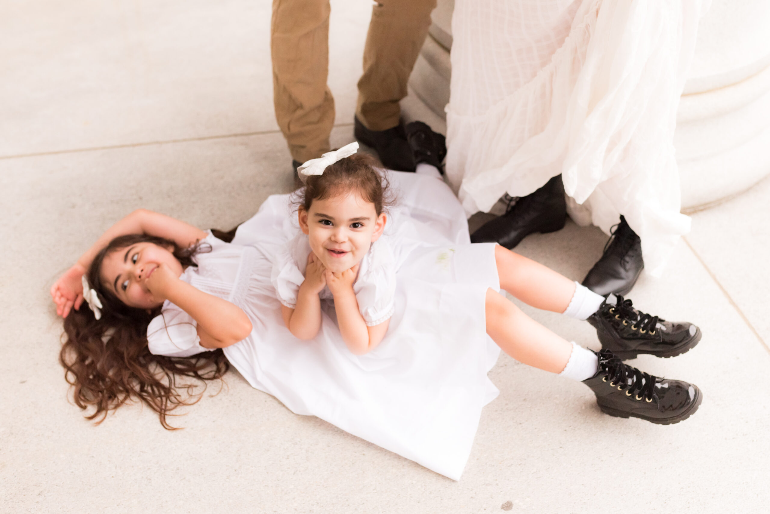 two kids laying on the floor