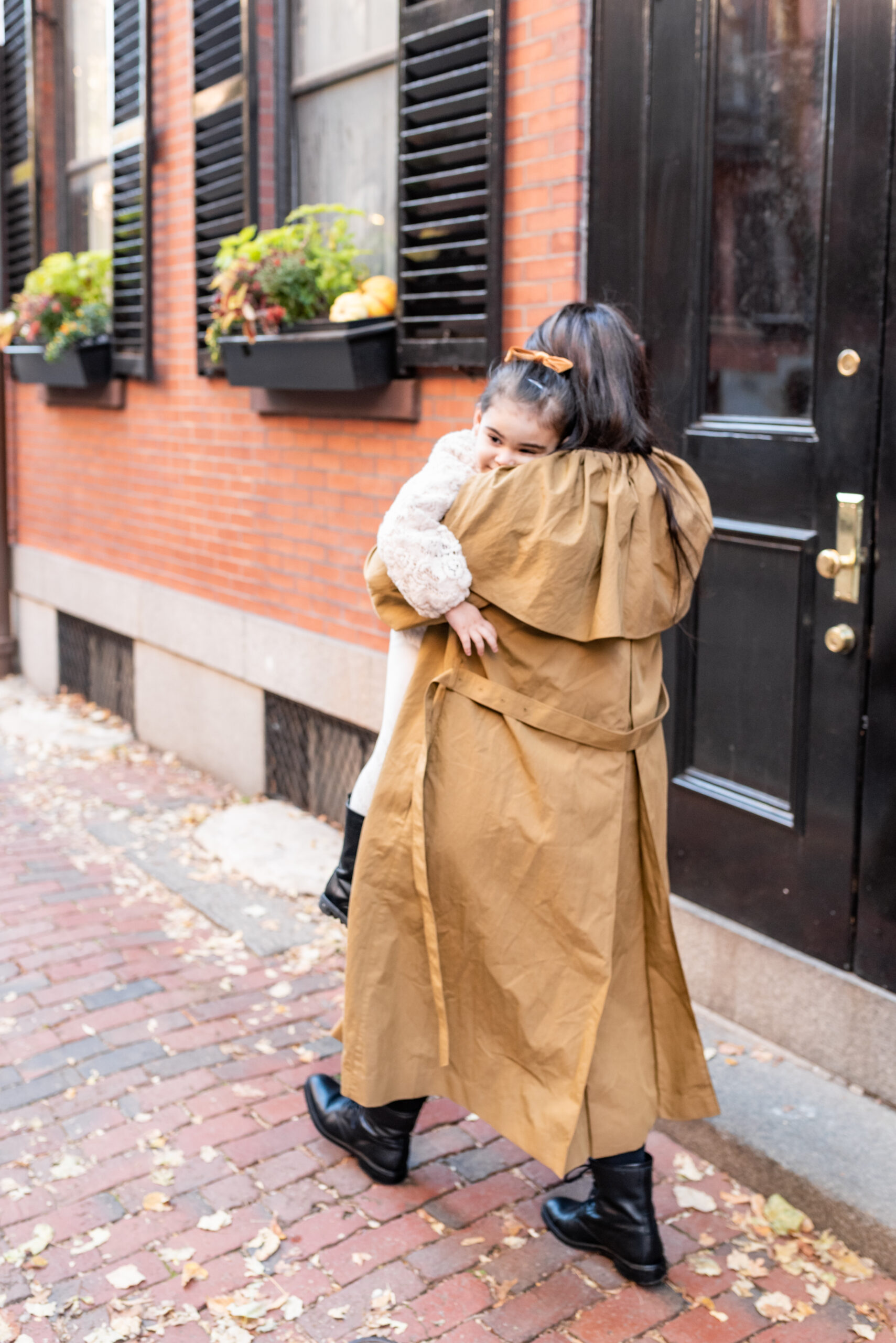 Holiday Family Photos mother carrying her daughter 