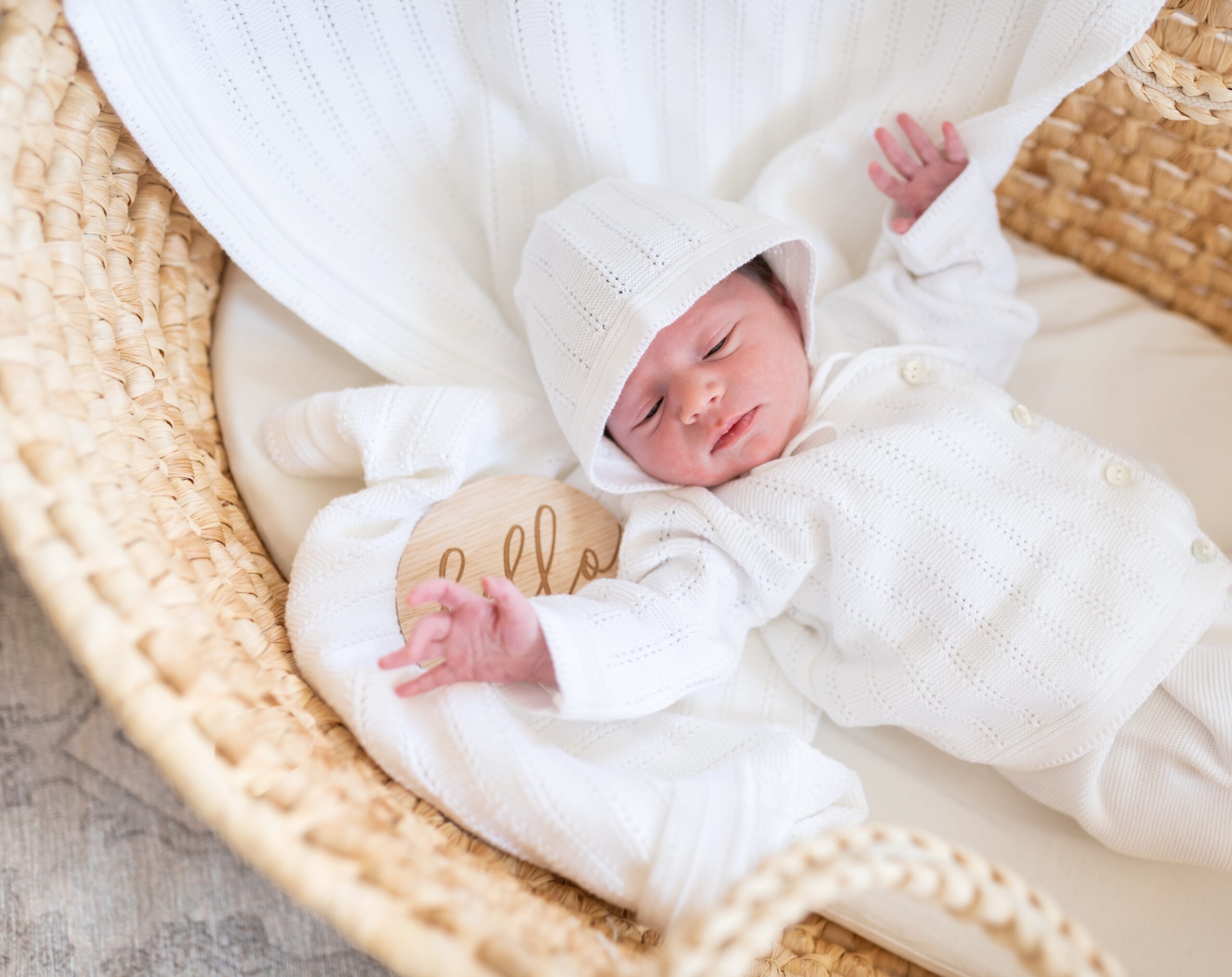 new born playing in a bassinet